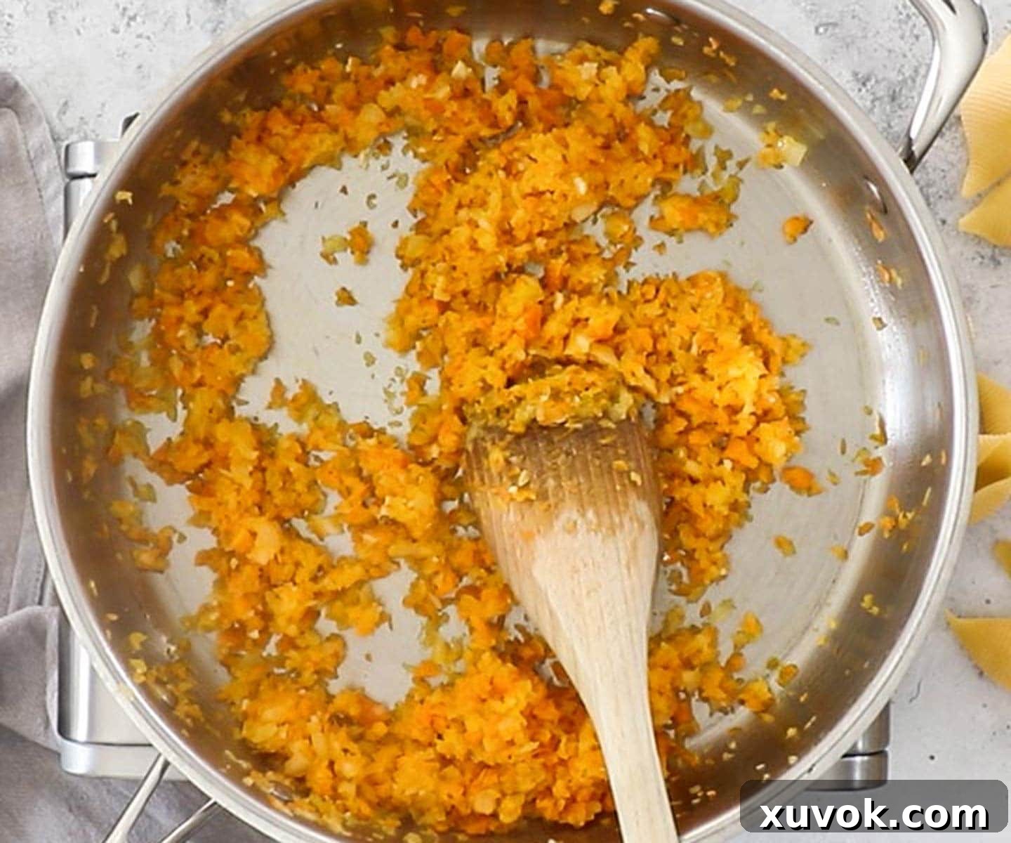 Carrots and onions cooking in a pan.