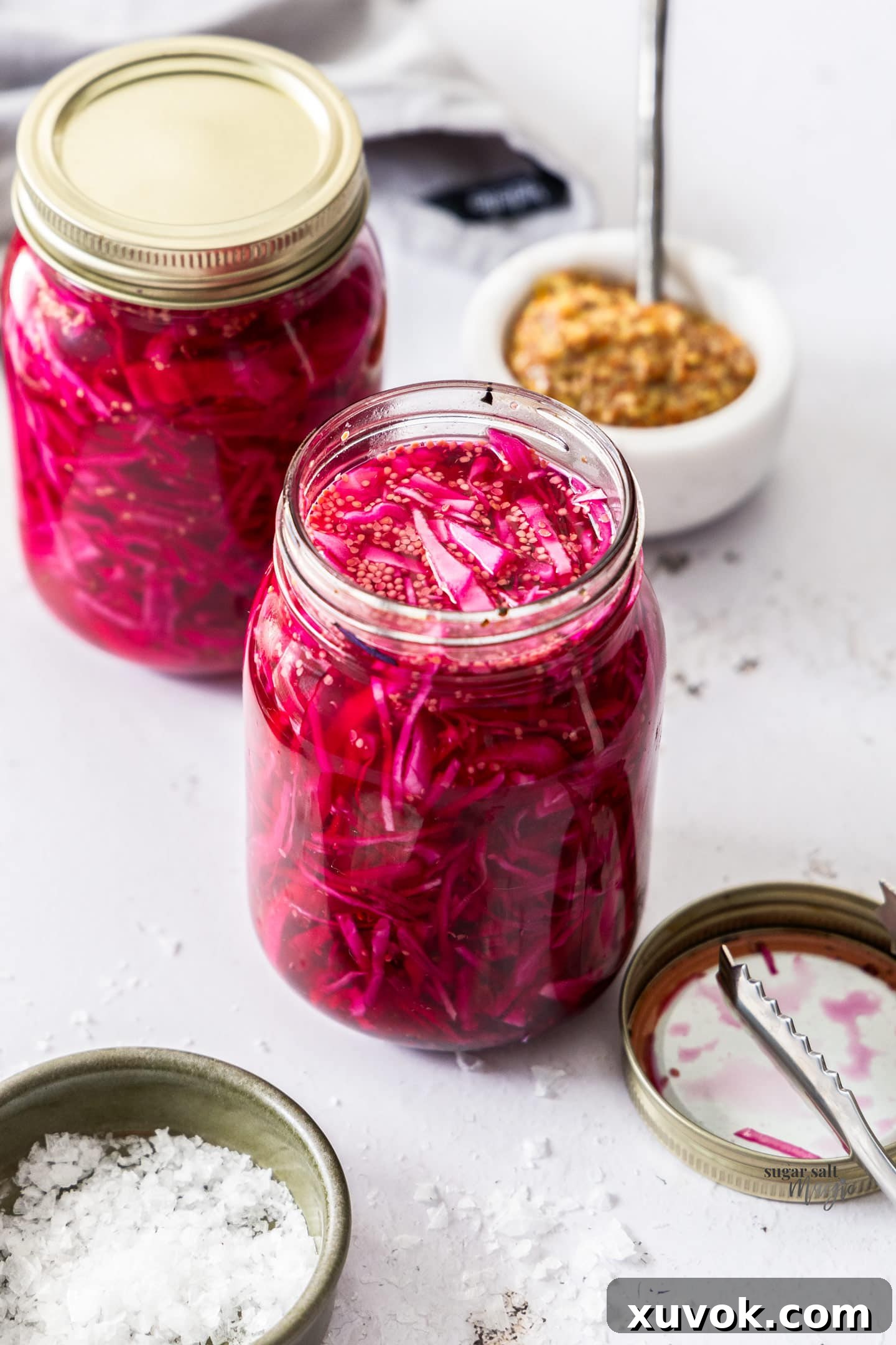 Looking down into a mason jar filled with vibrant pickled red cabbage.