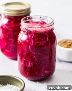 Closeup of a mason jar filled with pickled red cabbage.