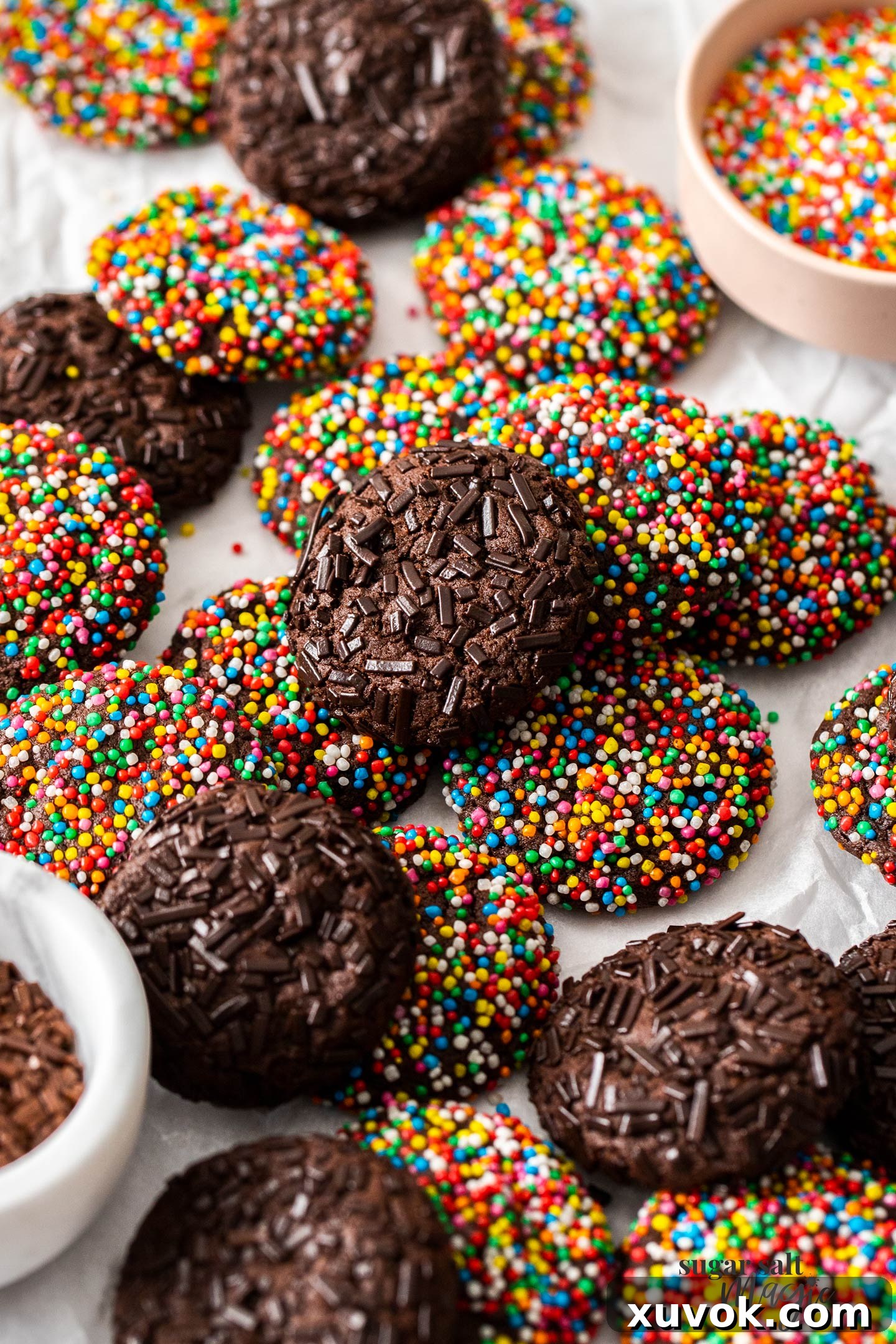 A generous pile of freshly baked chocolate sprinkle cookies on a serving plate, ready to be enjoyed.