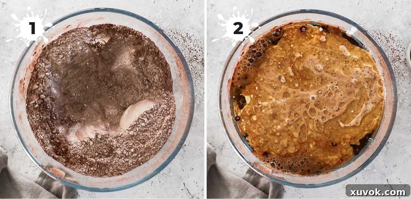 Two hands mixing together dry and wet ingredients in a large bowl to create a smooth, glossy chocolate cake batter.