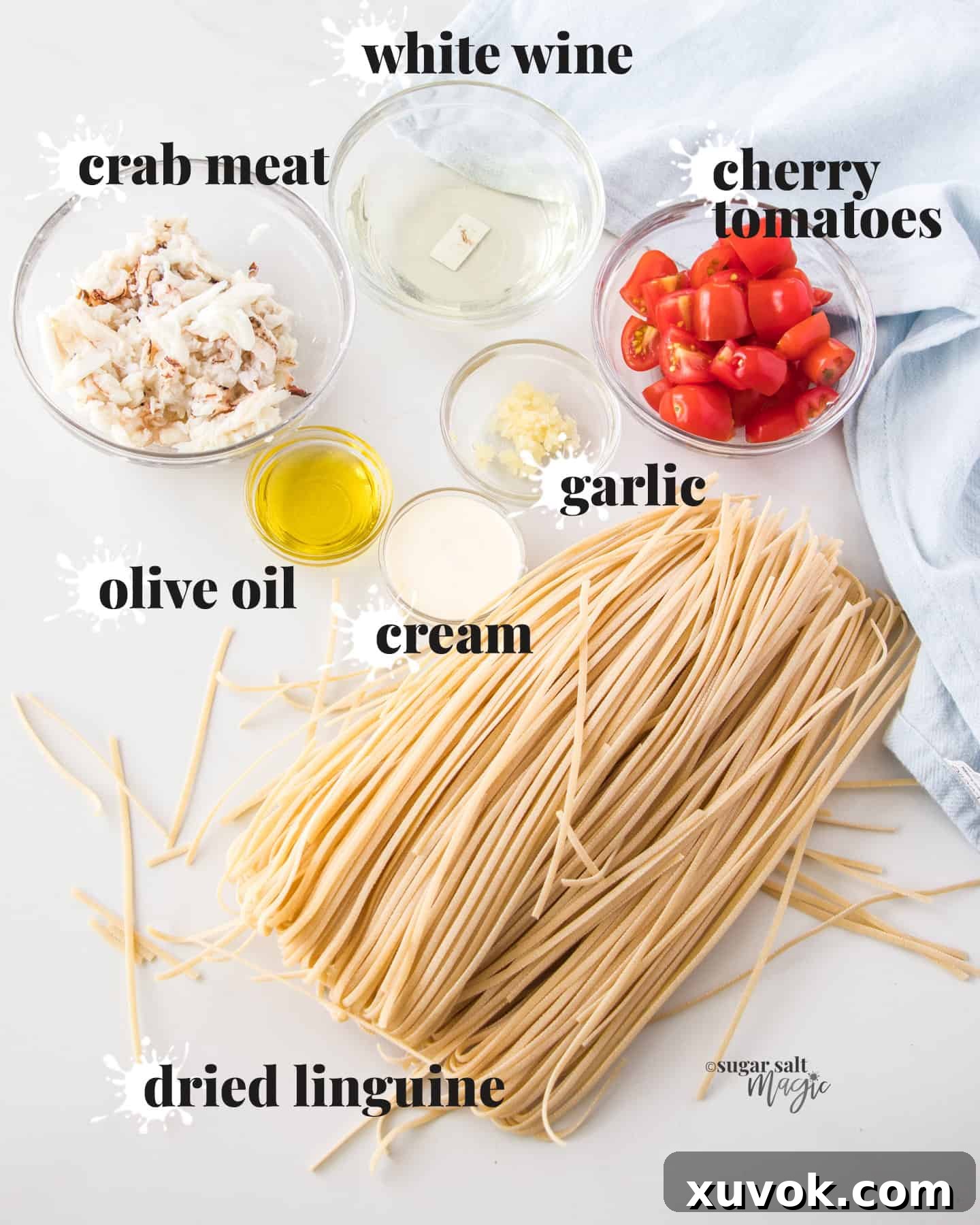 overhead: crab pasta ingredients on a benchtop