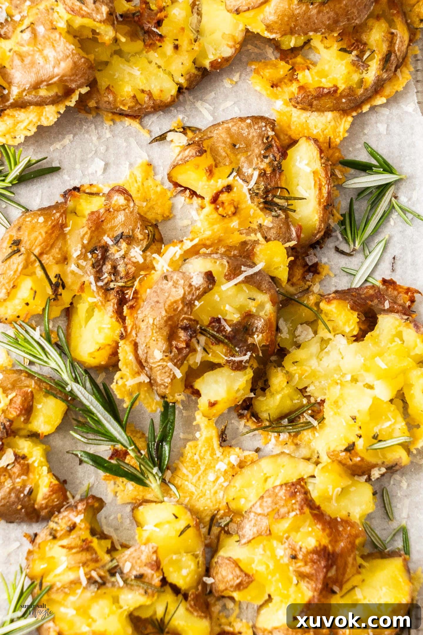 Top down view of a batch of parmesan smashed potatoes, golden and inviting.