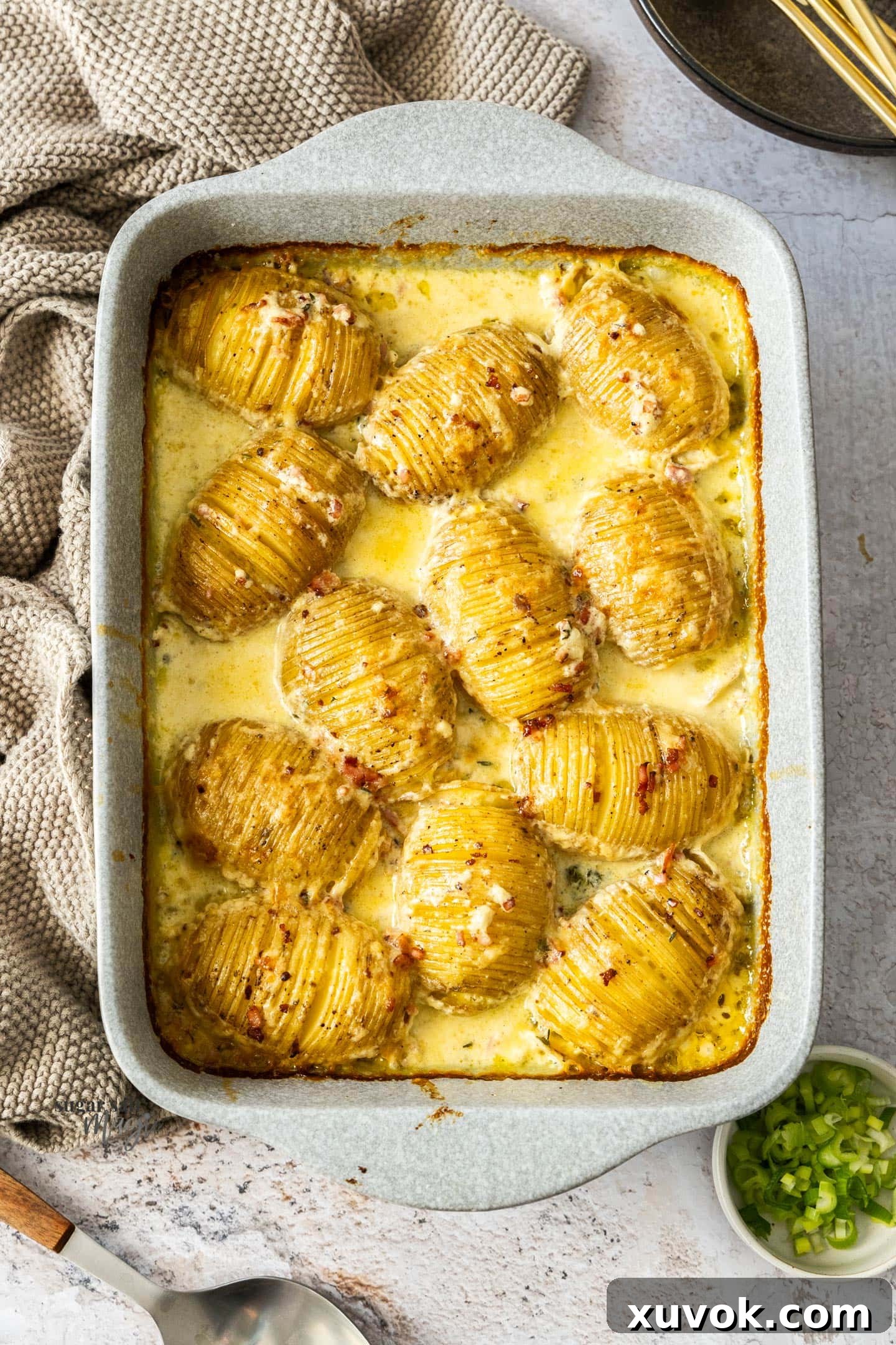 Roasted hasselback potatoes in cream in a casserole dish, a delectable Hasselback Potato Gratin.