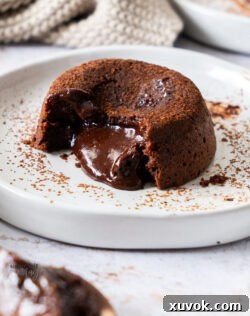 A chocolate fondant on a plate showing the gooey centre.