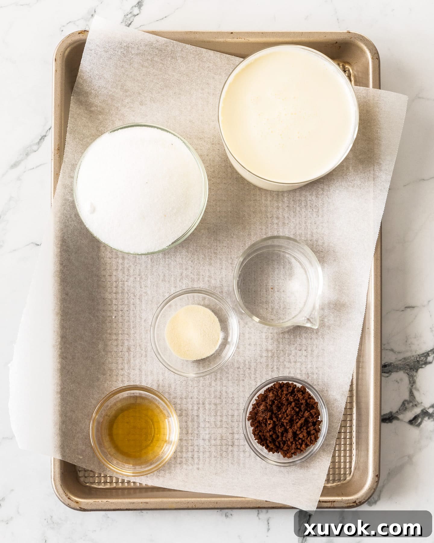 A beautifully arranged collection of the essential ingredients for making the easy coffee mousse, neatly presented on a wooden baking tray.