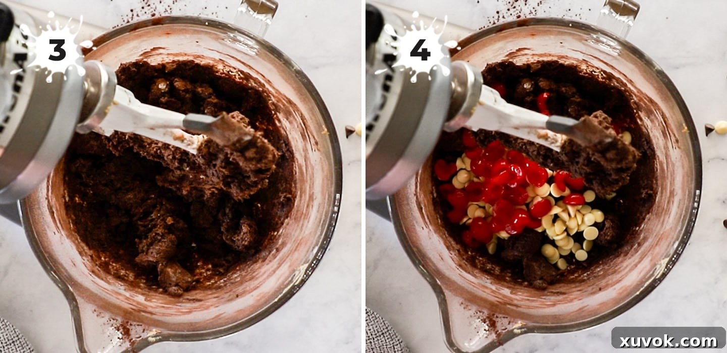 Generous amounts of dark and white chocolate chips and chopped maraschino cherries being gently folded into the rich, chocolatey cookie dough, preparing the mixture for baking.
