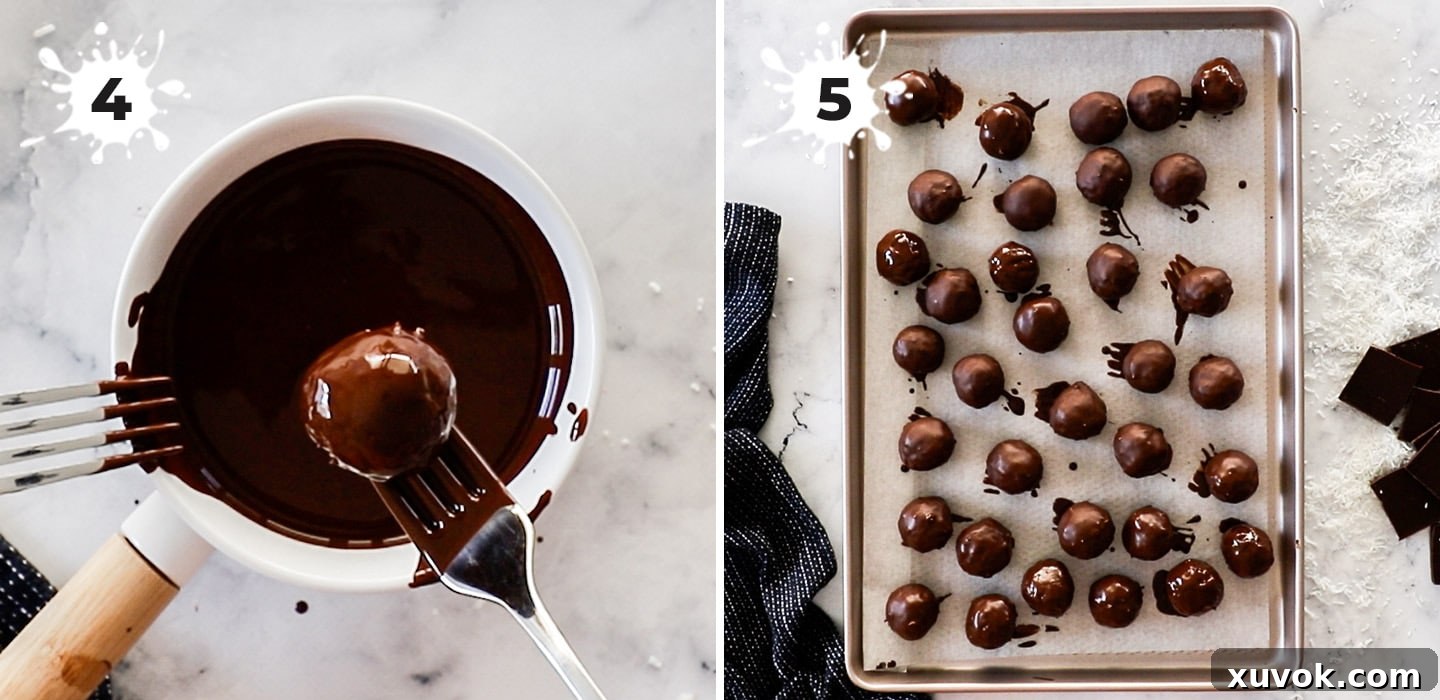 A close-up shot of coconut balls being coated in melted chocolate using a fork.