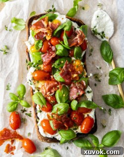 Top down view of a whole Slow Roasted Tomato Bruschetta, ready to be sliced and served.