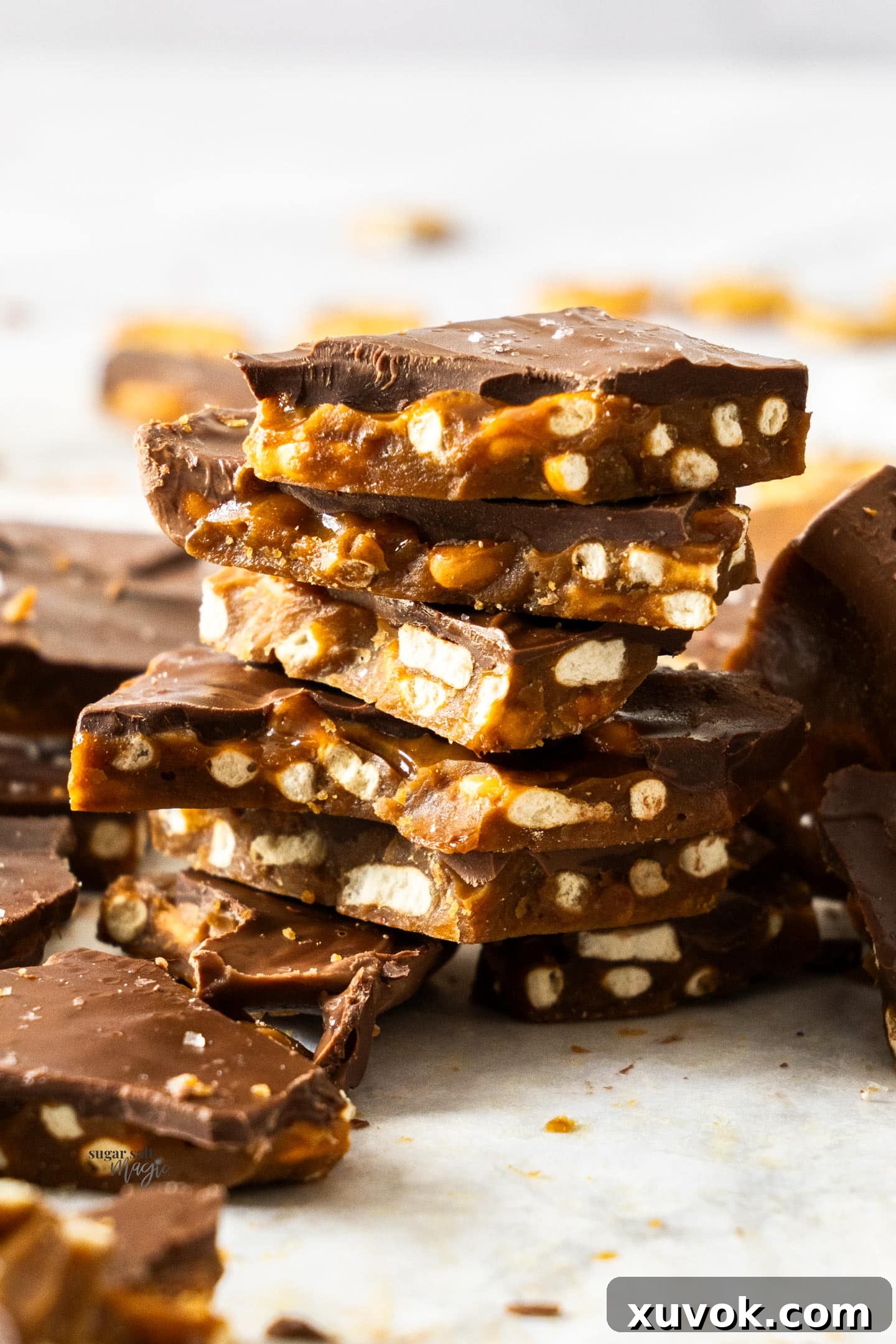 A stack of delicious pretzel Christmas crack pieces, showcasing the different layers of toffee, pretzels, and chocolate.