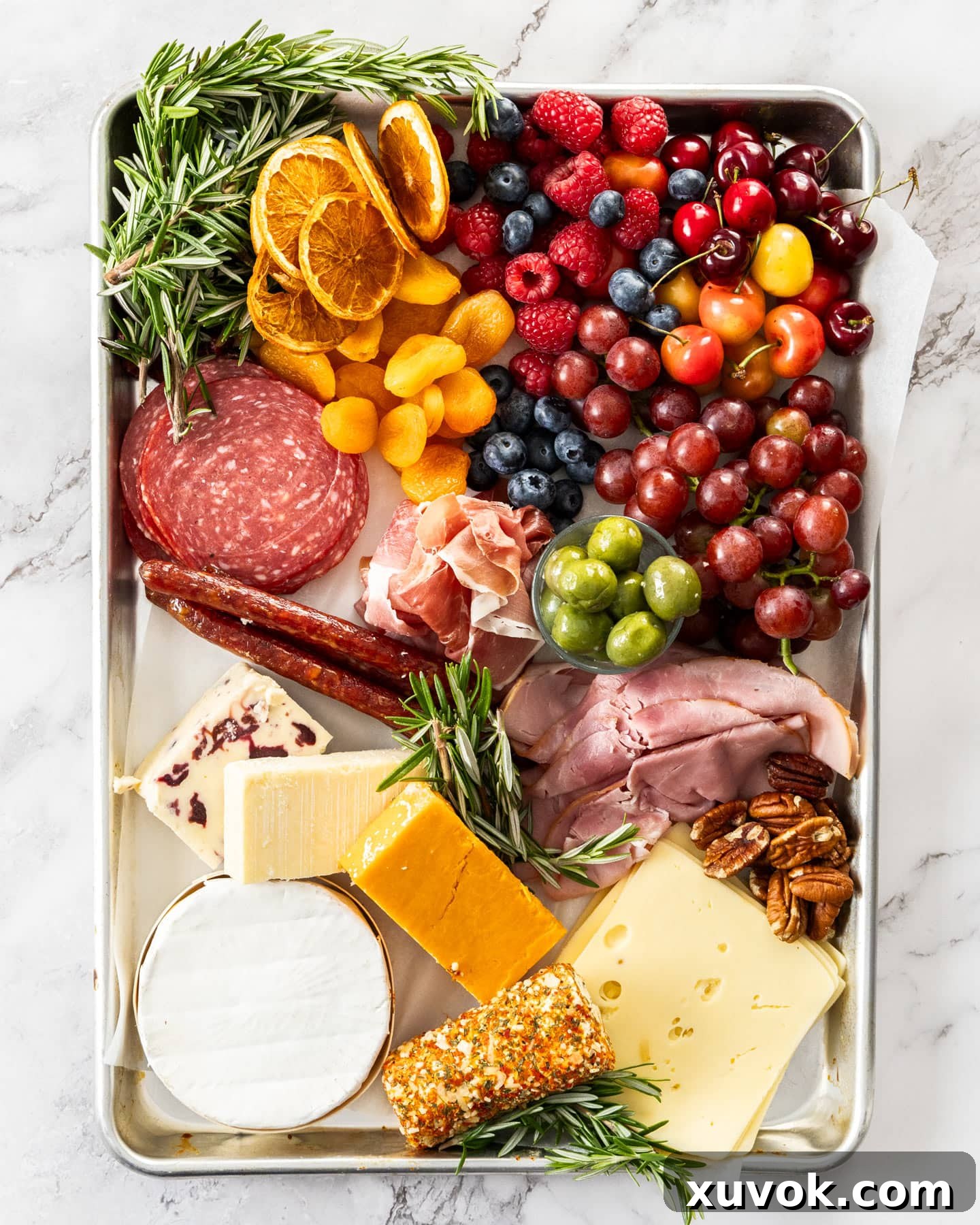 Ingredients for the charcuterie board on a baking tray.