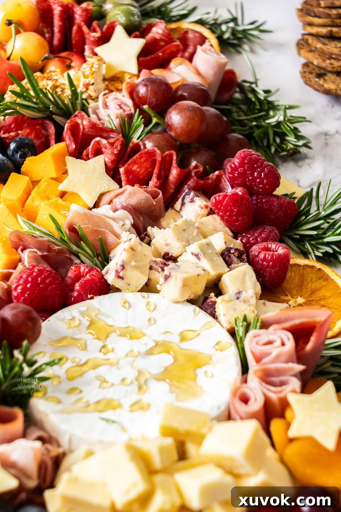 Closeup of some of the cheeses and berries.