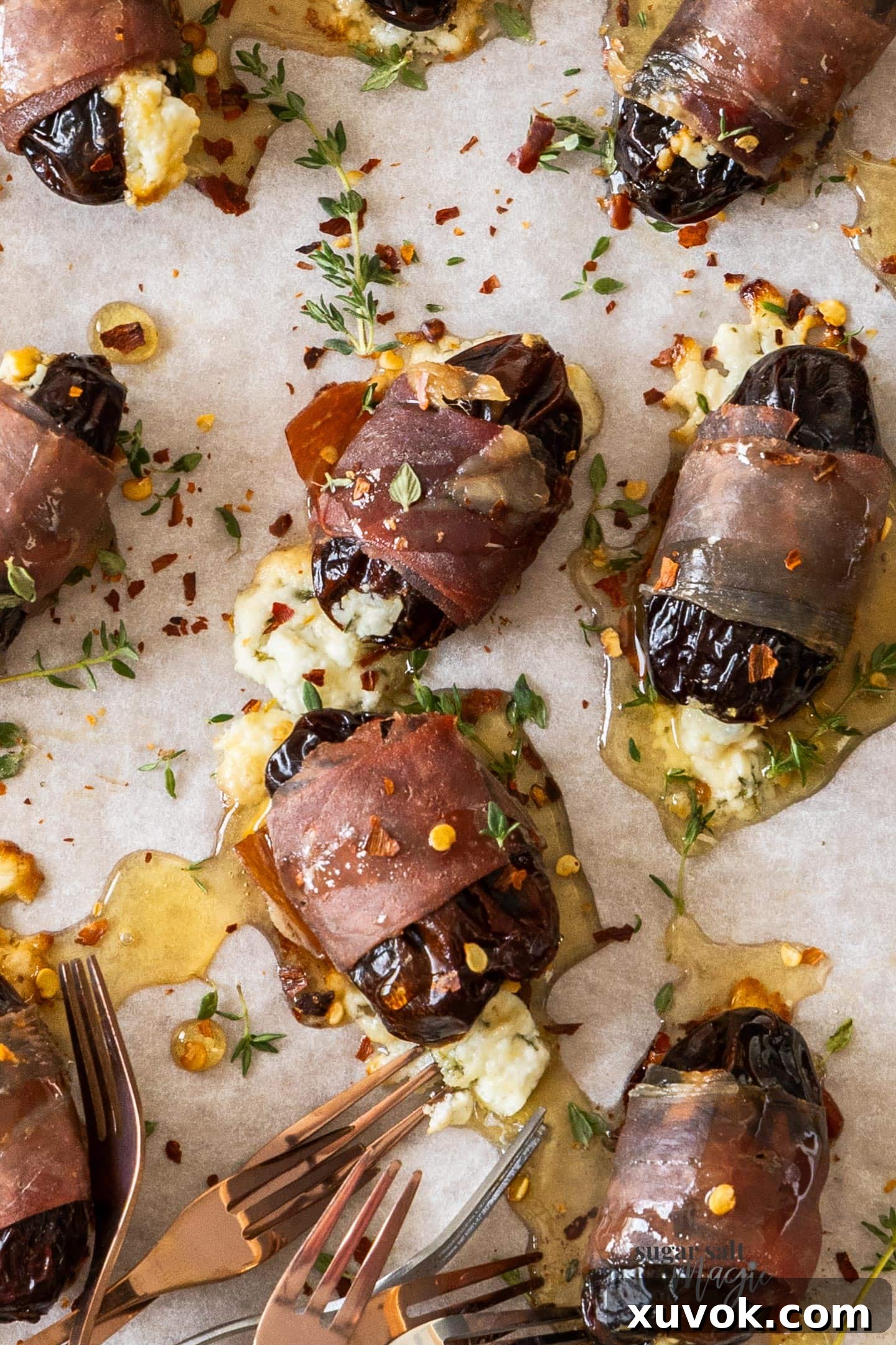 Top down view of 8 prosciutto wrapped dates, showcasing their golden-brown exterior and juicy texture.