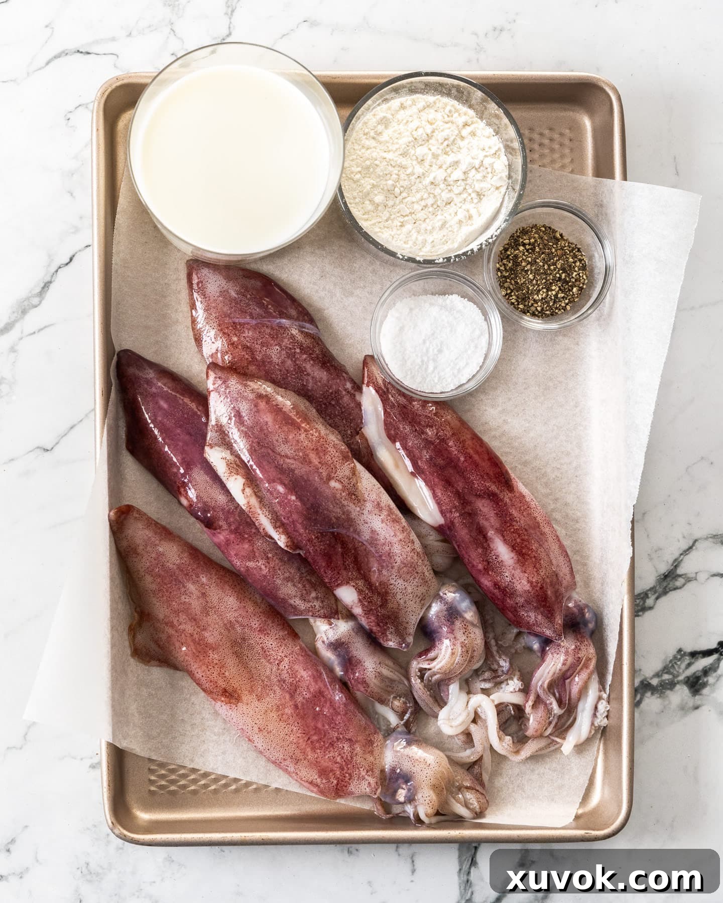 Ingredients for salt and pepper squid on a baking tray.