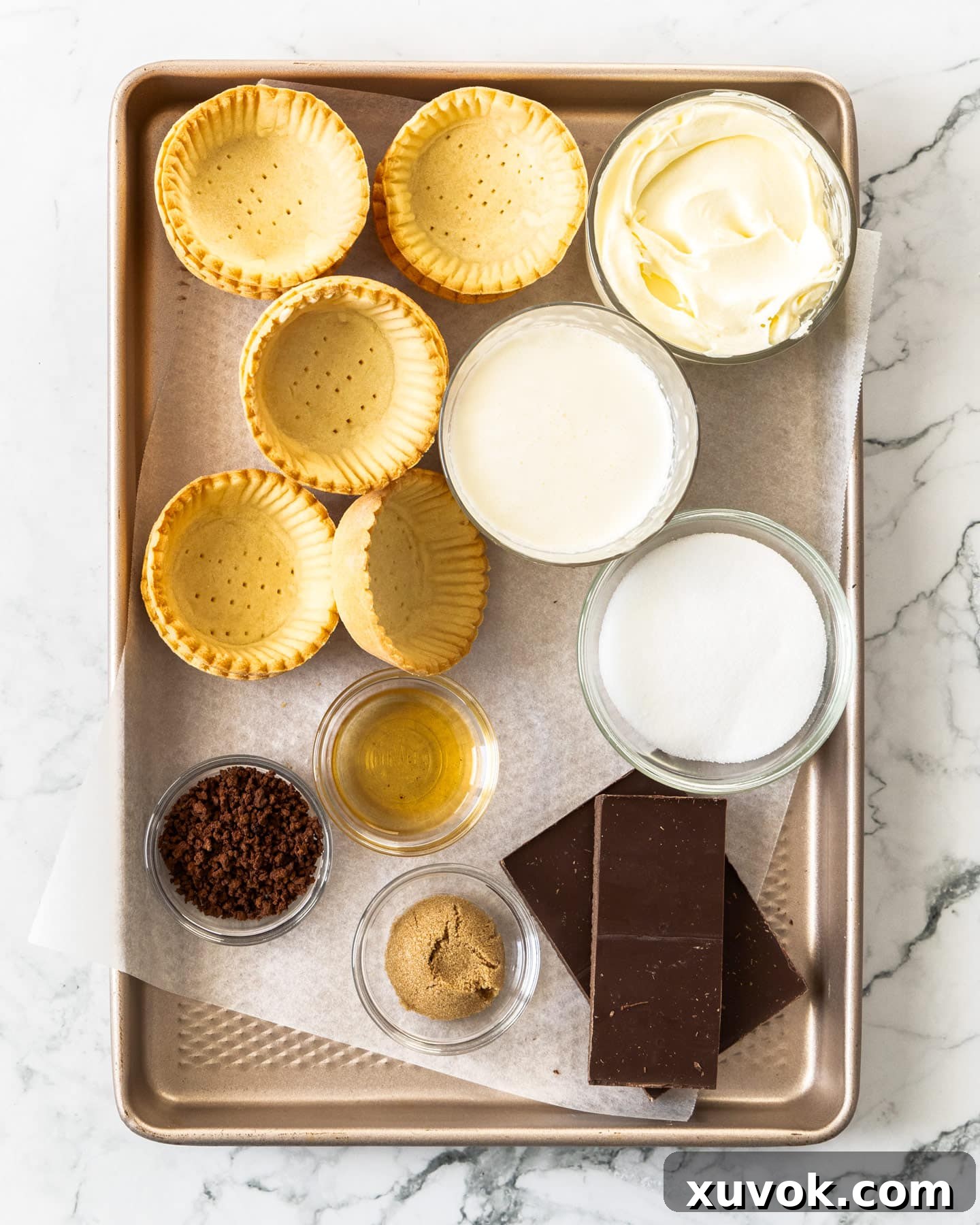Ingredients for tiramisu tartlets on a baking tray.