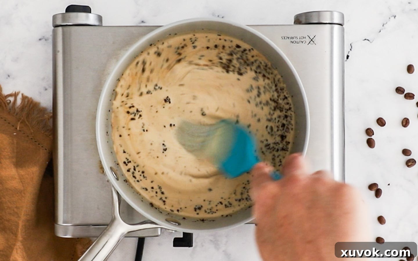 Dissolving coffee granules into cream.