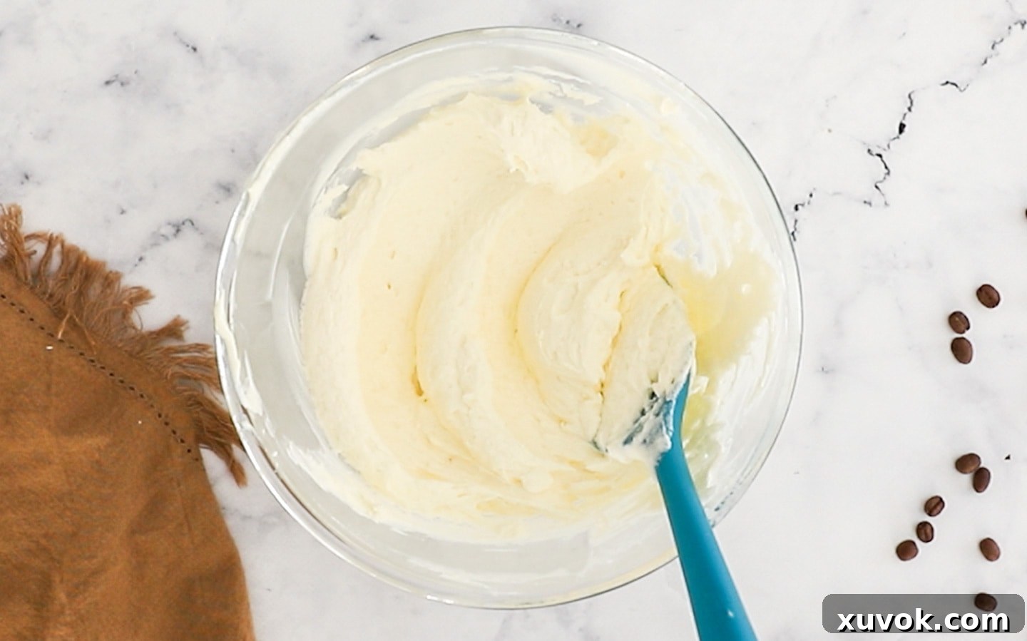 Mascarpone with cream folded through in a bowl.