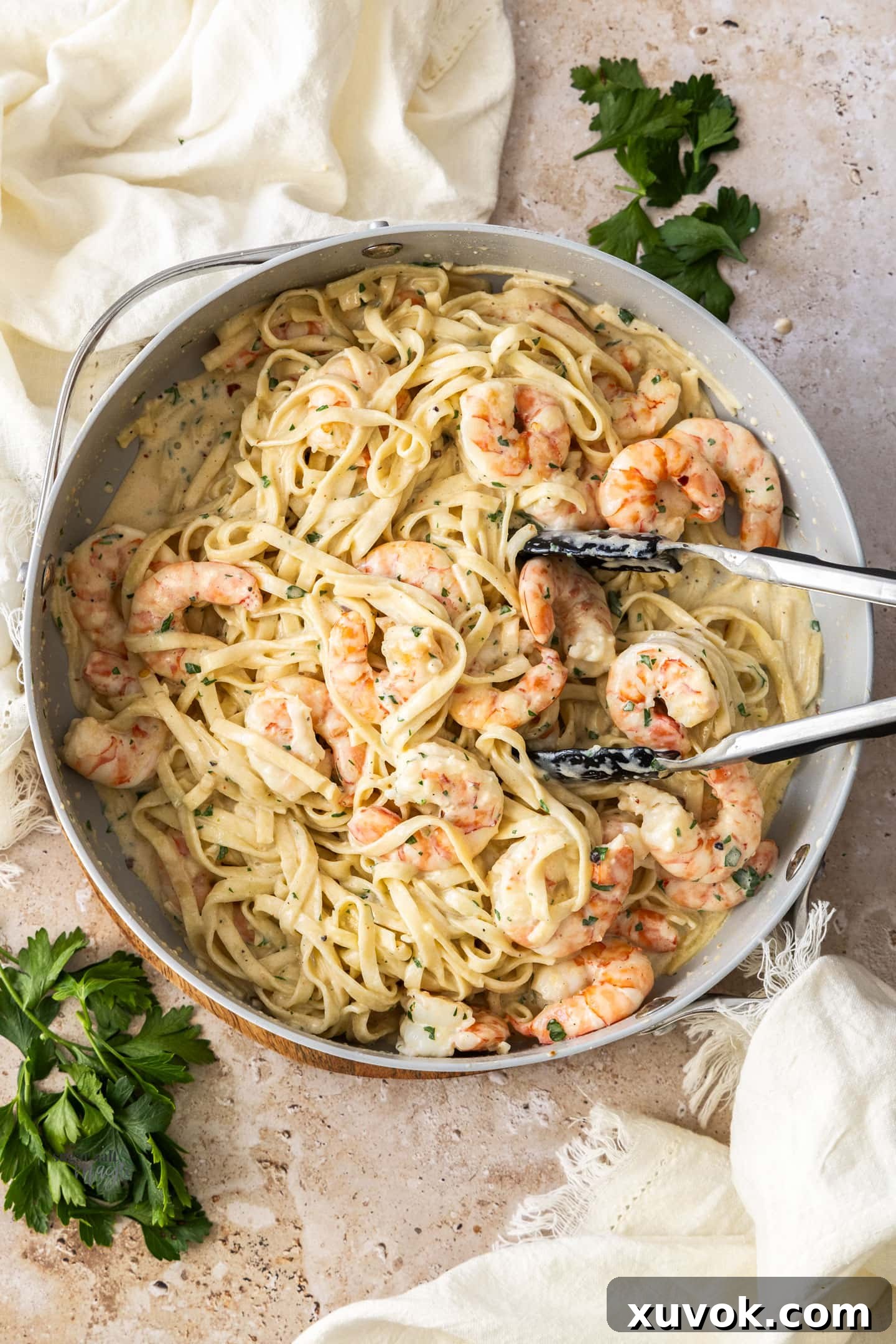 Top down view of creamy prawn pasta in a pan, showcasing its rich sauce and generous prawns.