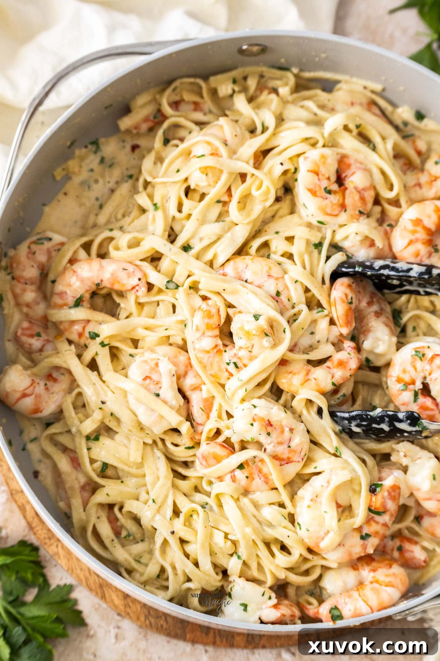 Closeup of the creamy pasta in a pan, highlighting the abundant, perfectly cooked prawns and the luscious sauce.