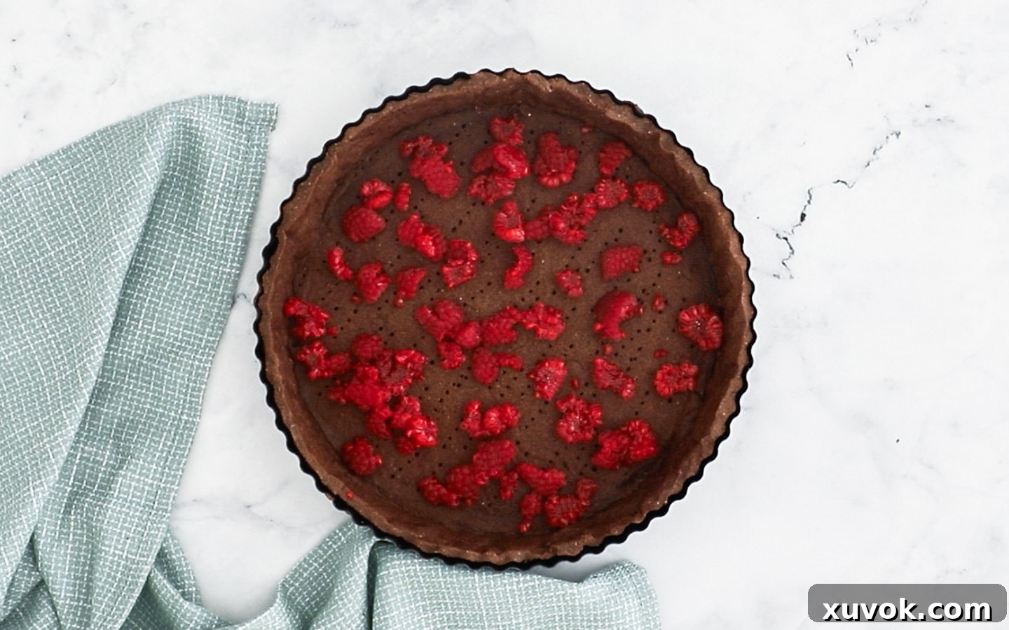 Adding torn raspberries to the base.