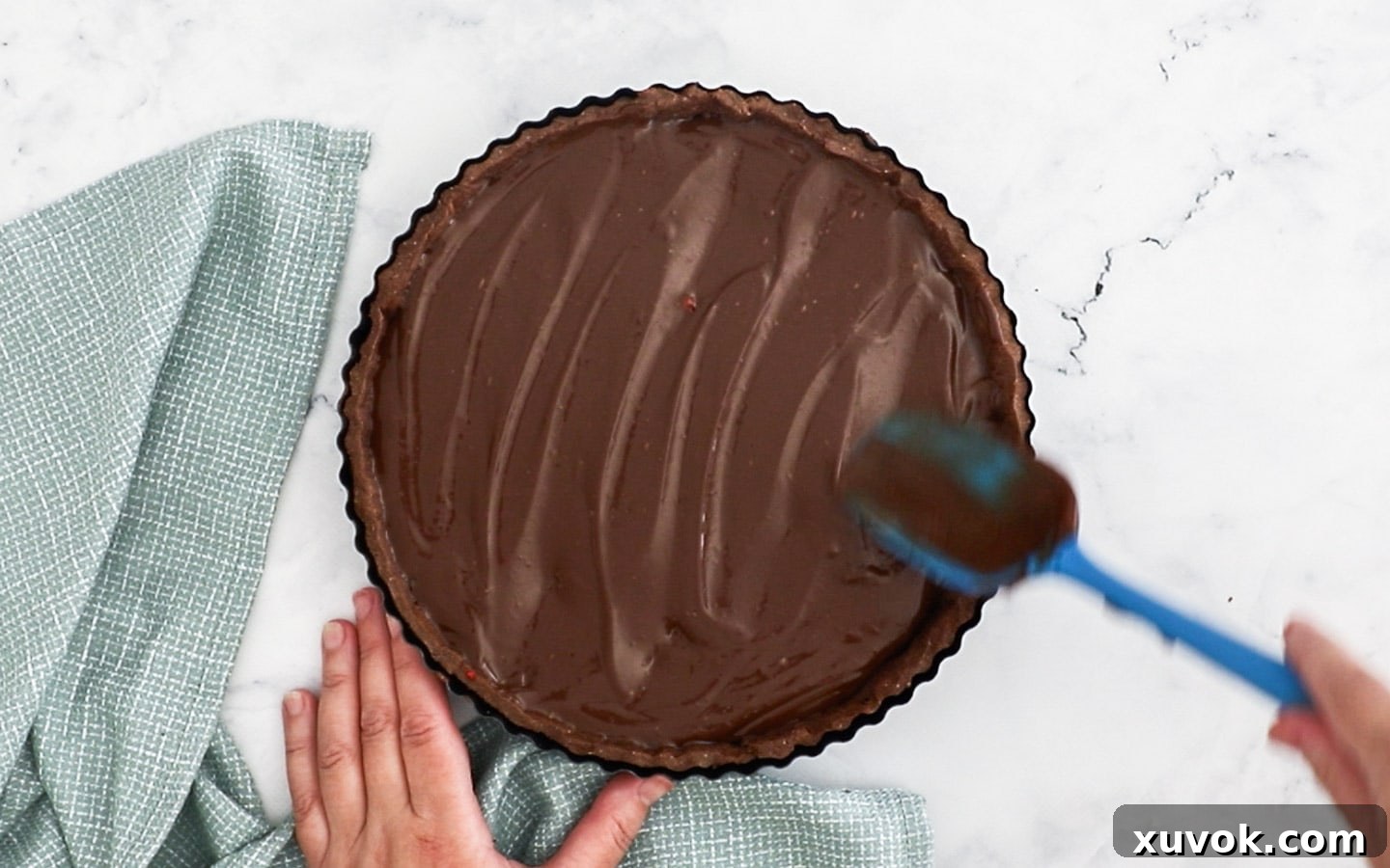 Swirling the chocolate cremeux over the top.