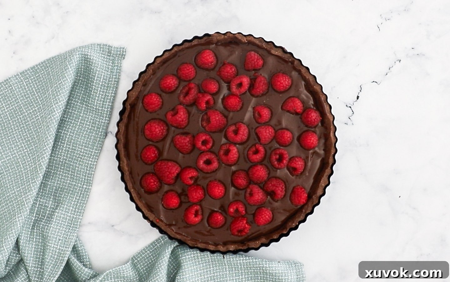 Raspberries added to the top of the tart.