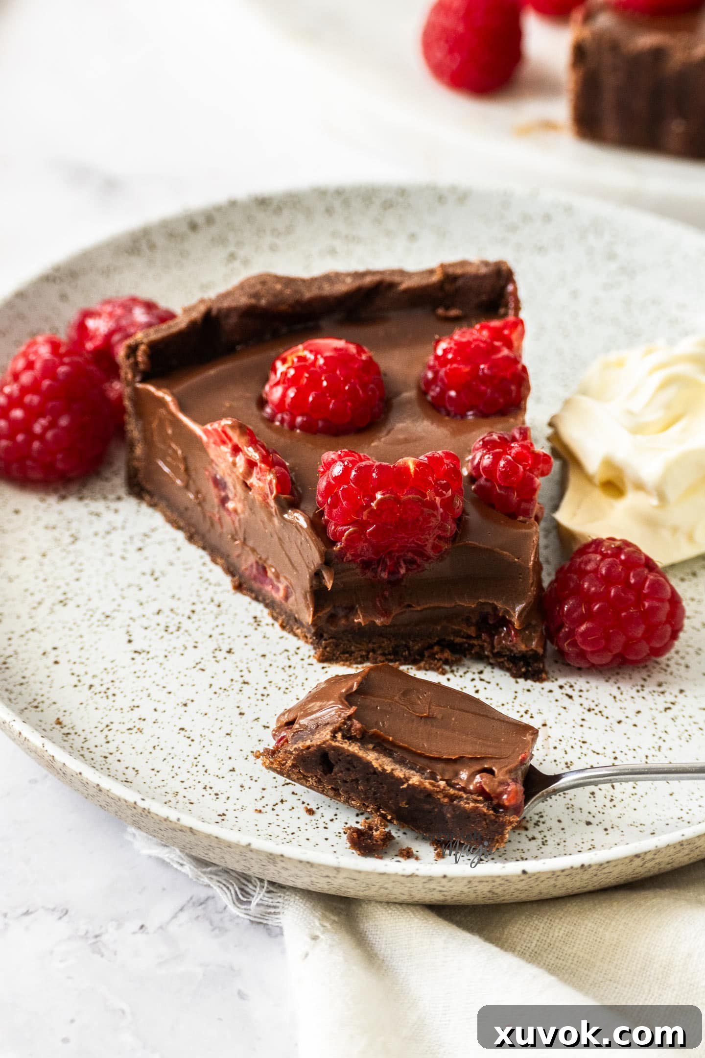 A slice of tart with a piece cut away.
