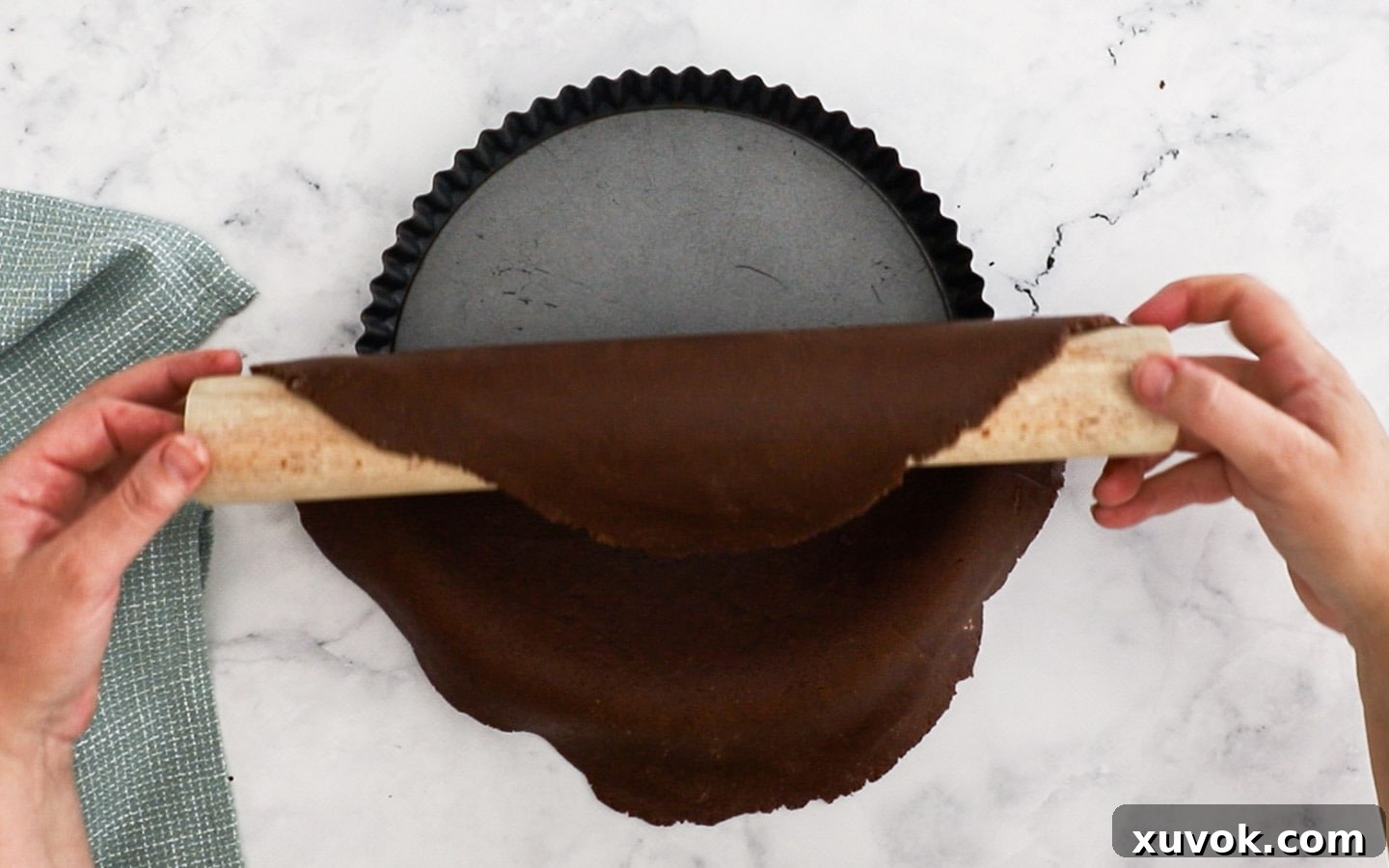 Placing the pastry dough into the tart pan.