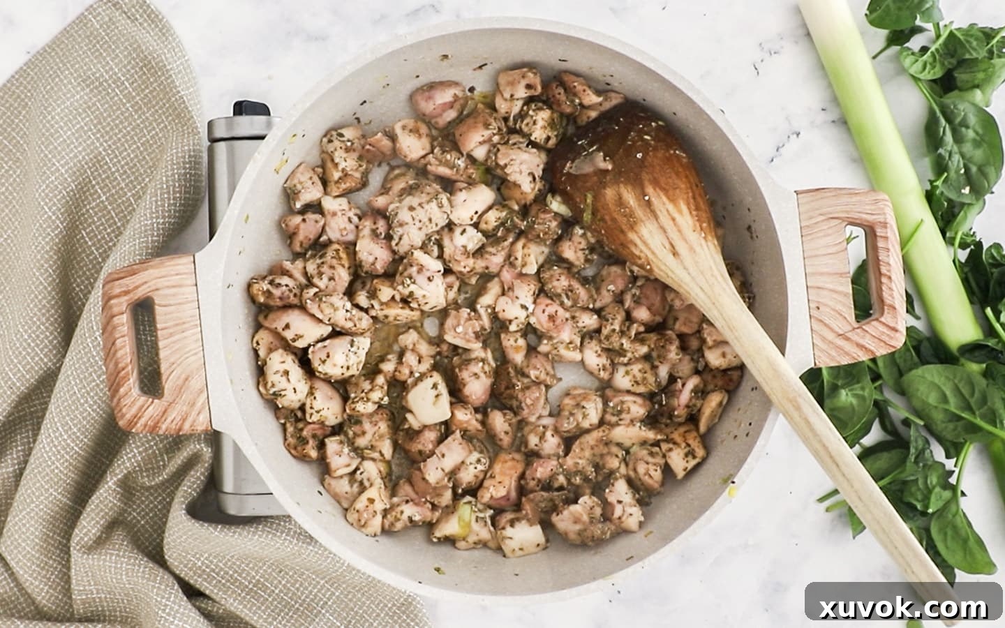 The chicken pieces are nearly cooked through, showing a light golden-brown color from the seasoning.
