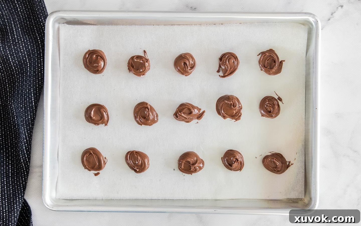 Swirls of Nutella on a baking tray.