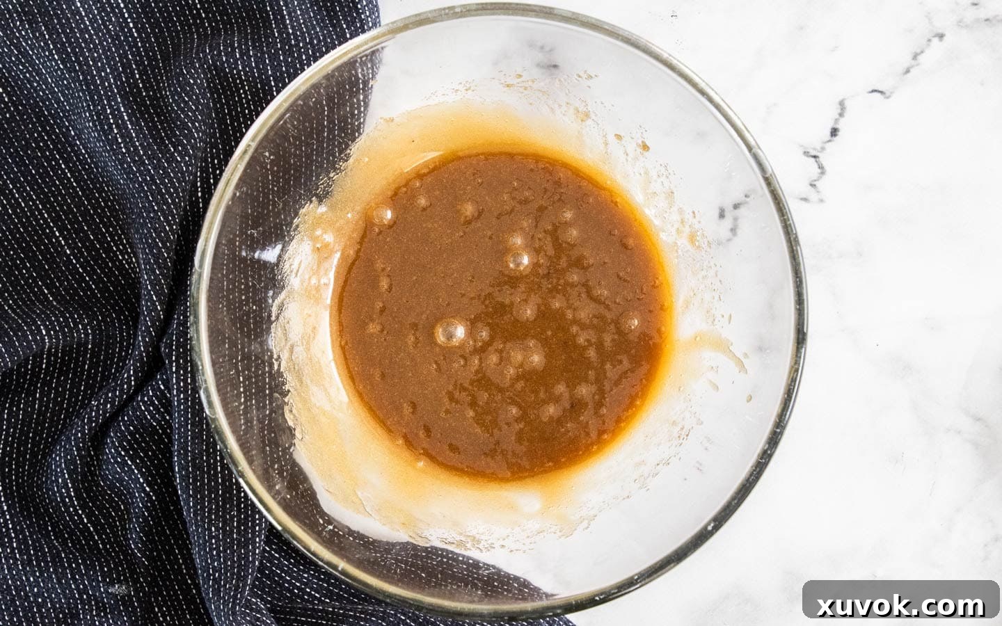 The butter, sugar and eggs whisked together in a bowl.