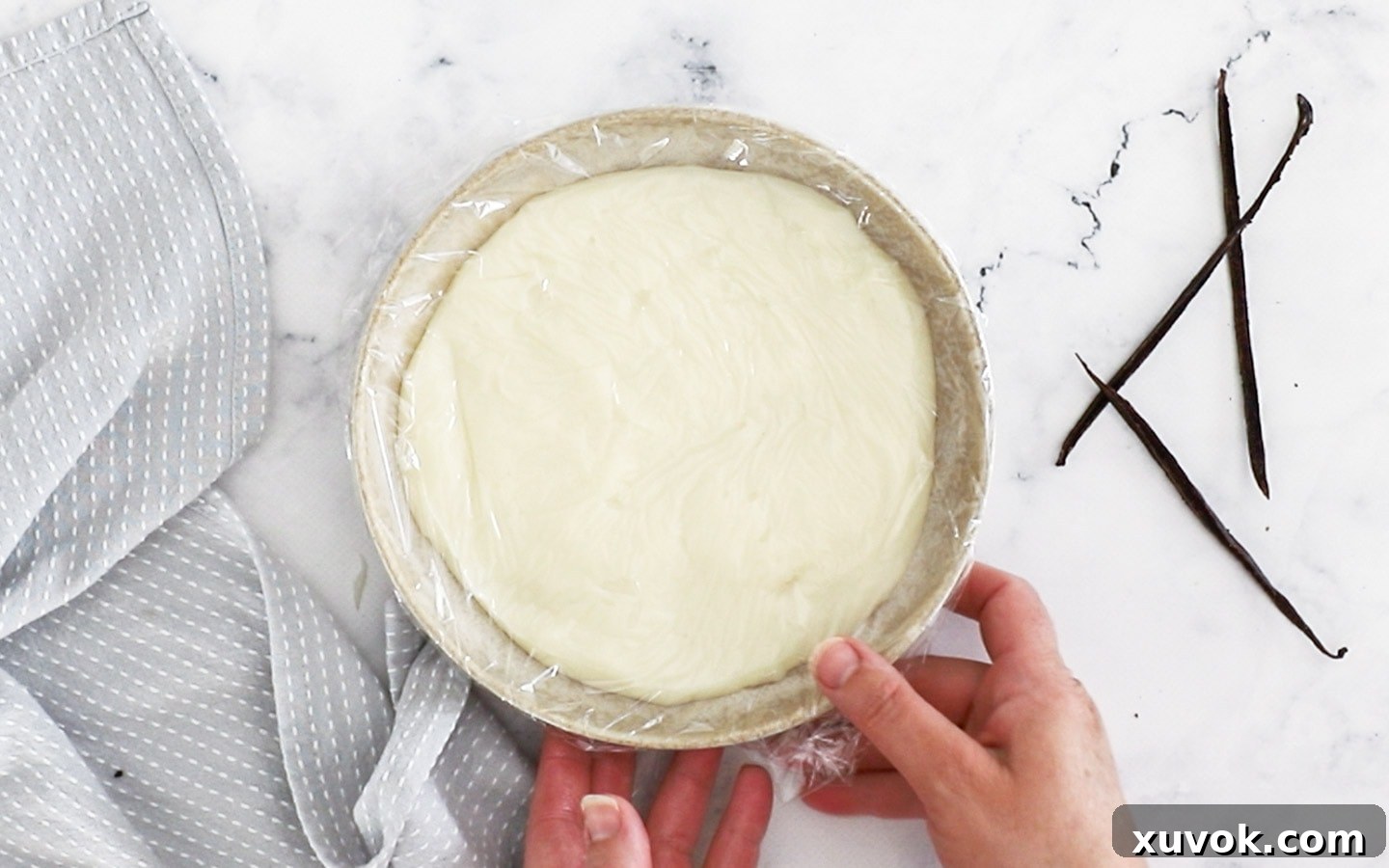 The cooked milk and flour pudding base spread in a flat dish, cooling.