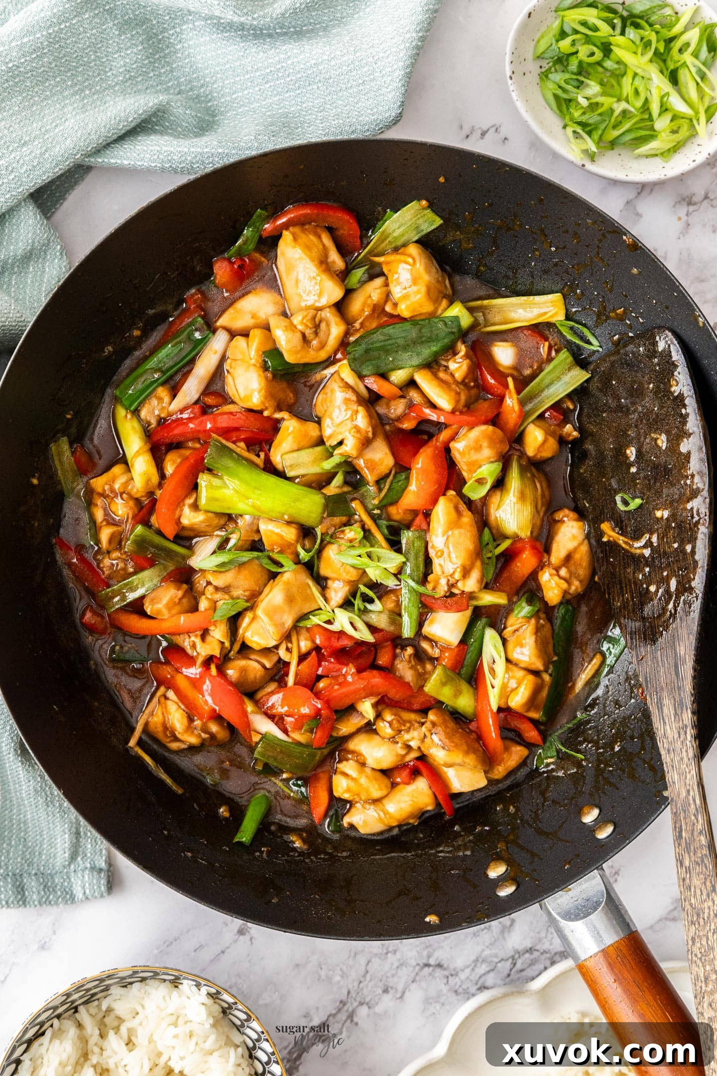 A wok full of glistening chicken in oyster sauce, ready to serve.