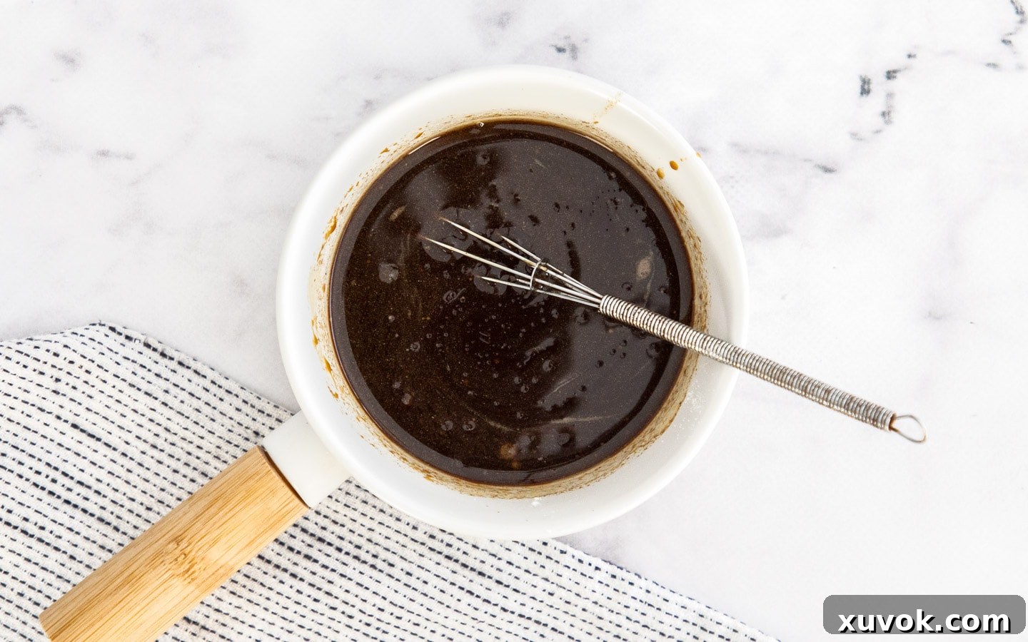 The savory oyster sauce mixture prepared in a small jug.