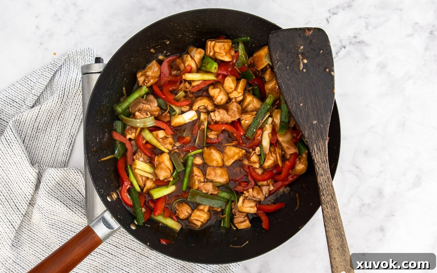 The vibrant green parts of spring onions added to the finished stir-fry.