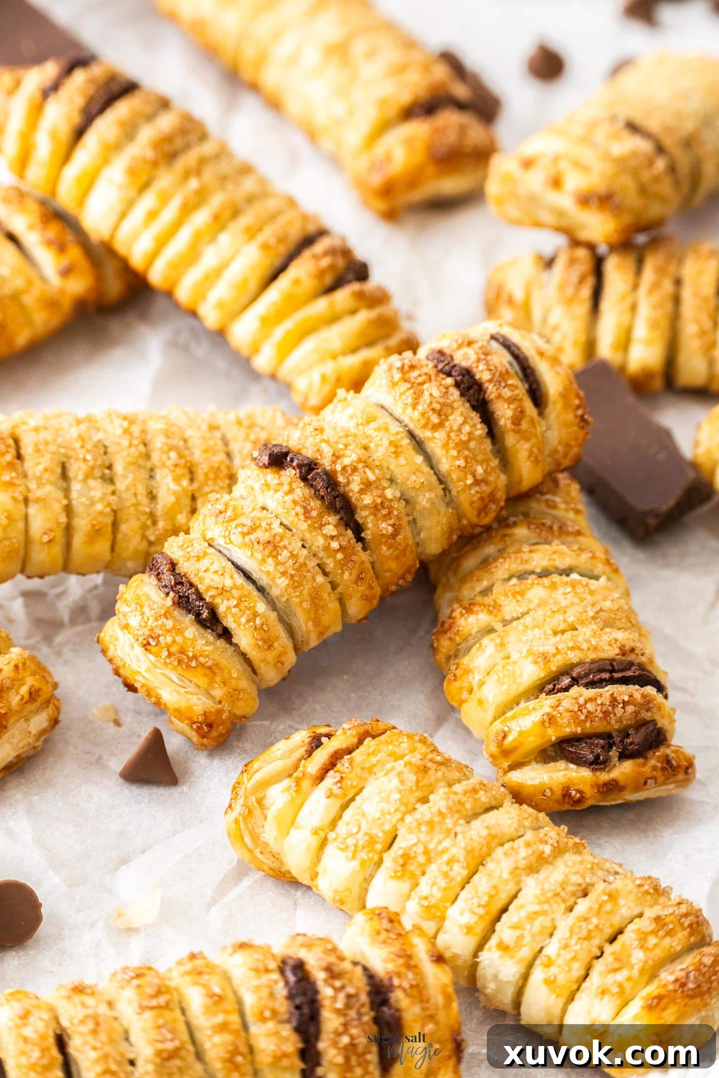 A batch of baked chocolate pastry puffs.