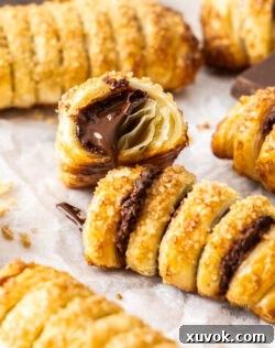 Closeup of a chocolate pastry puff broken open to show the inside.