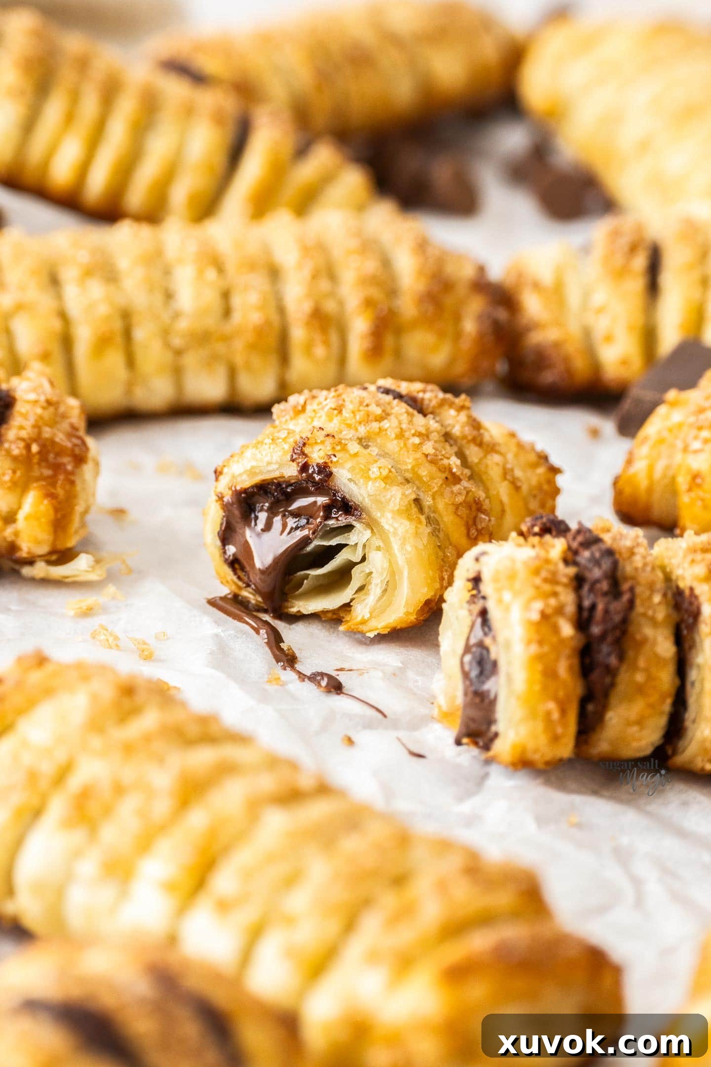 A chocolate puff pastry broken open to show the gooey chocolate inside.