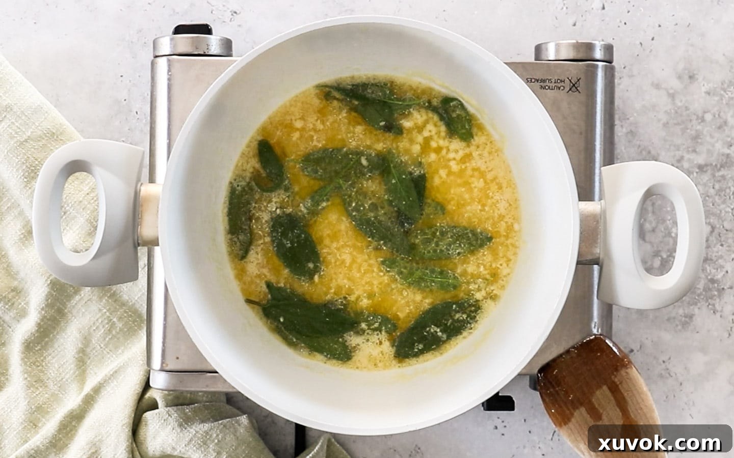 The butter with fresh sage leaves and minced garlic added, beginning to foam.