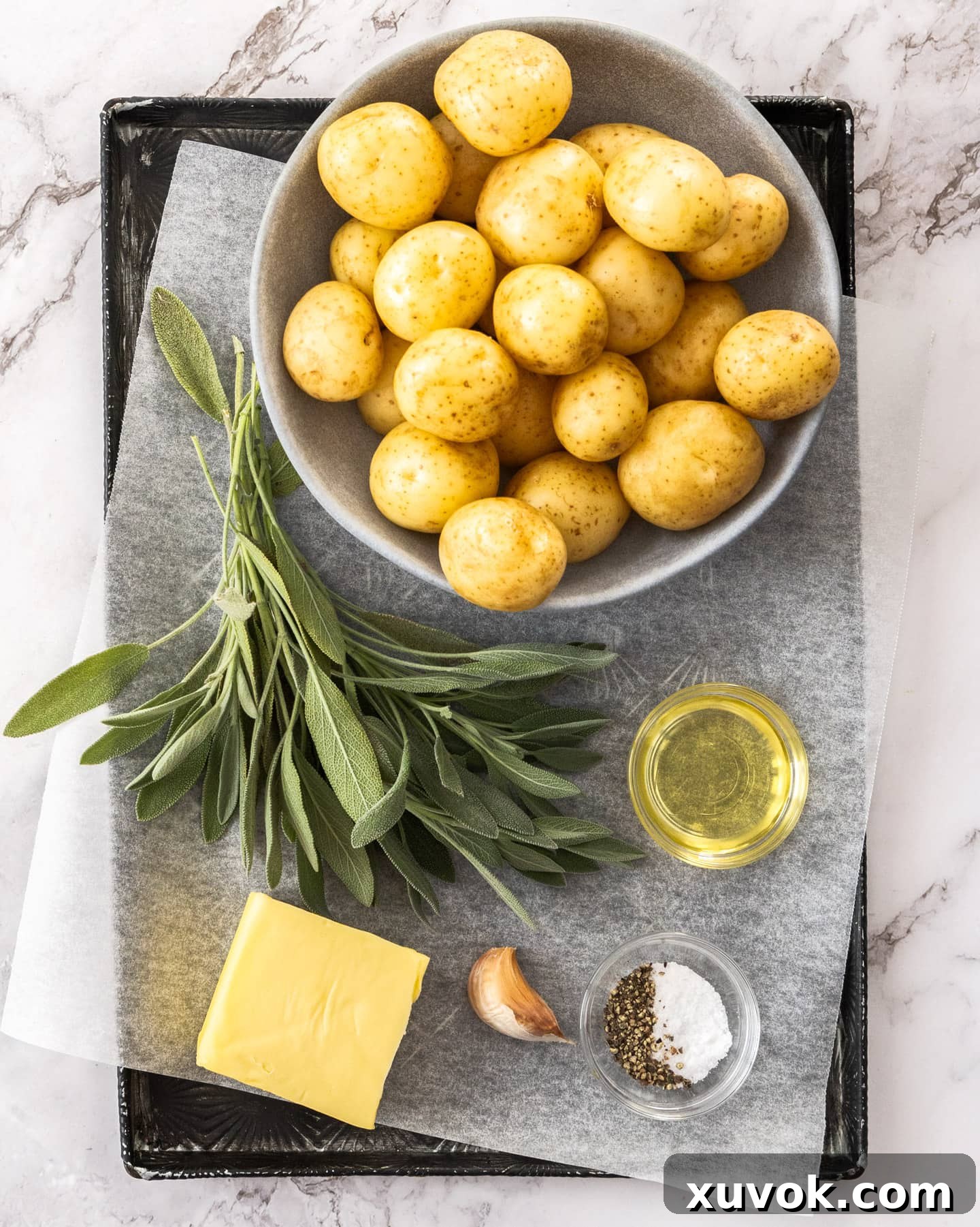 Ingredients for roasted mini potatoes on a tray.