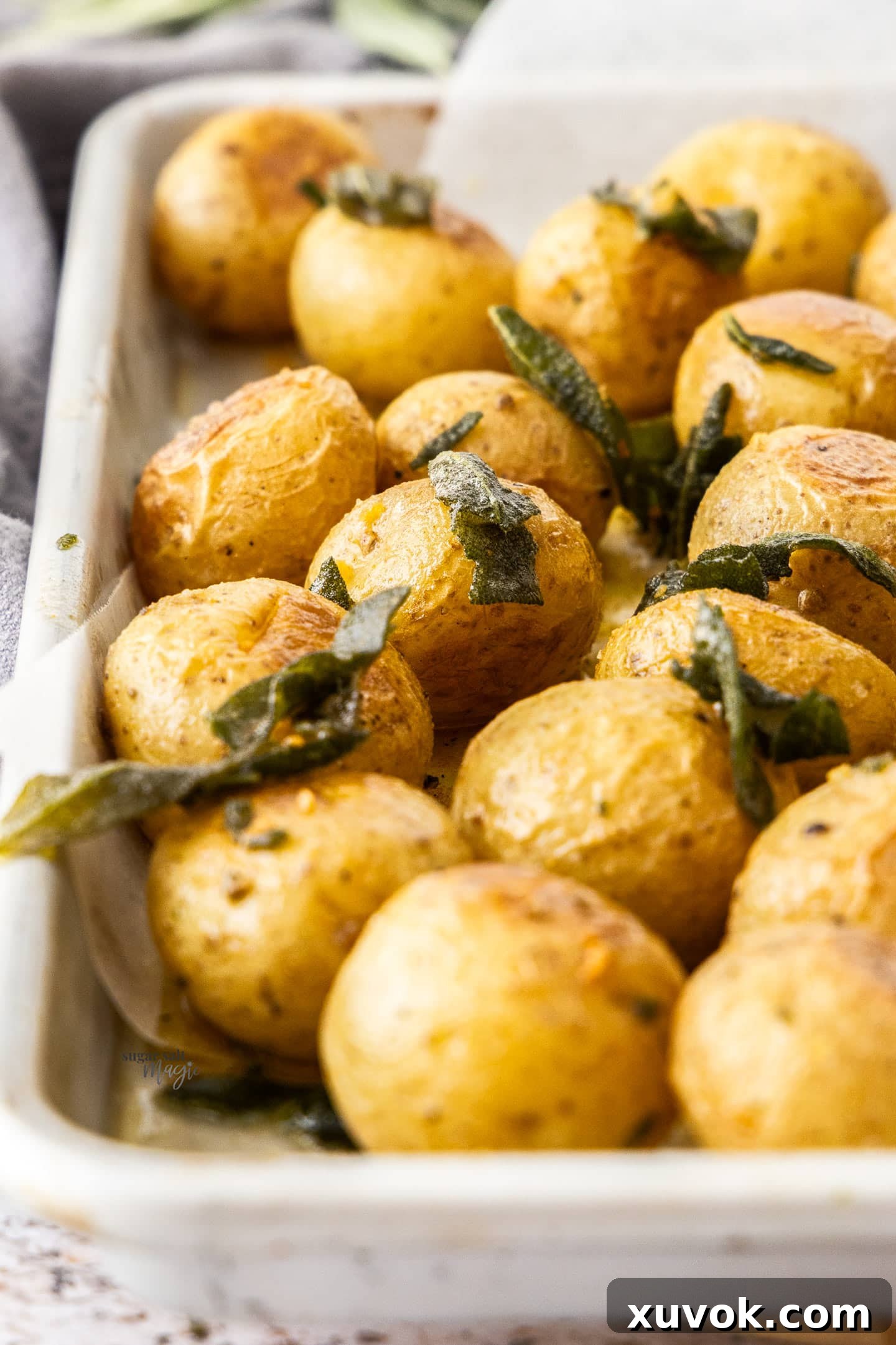 Closeup of roasted baby potatoes with sage.