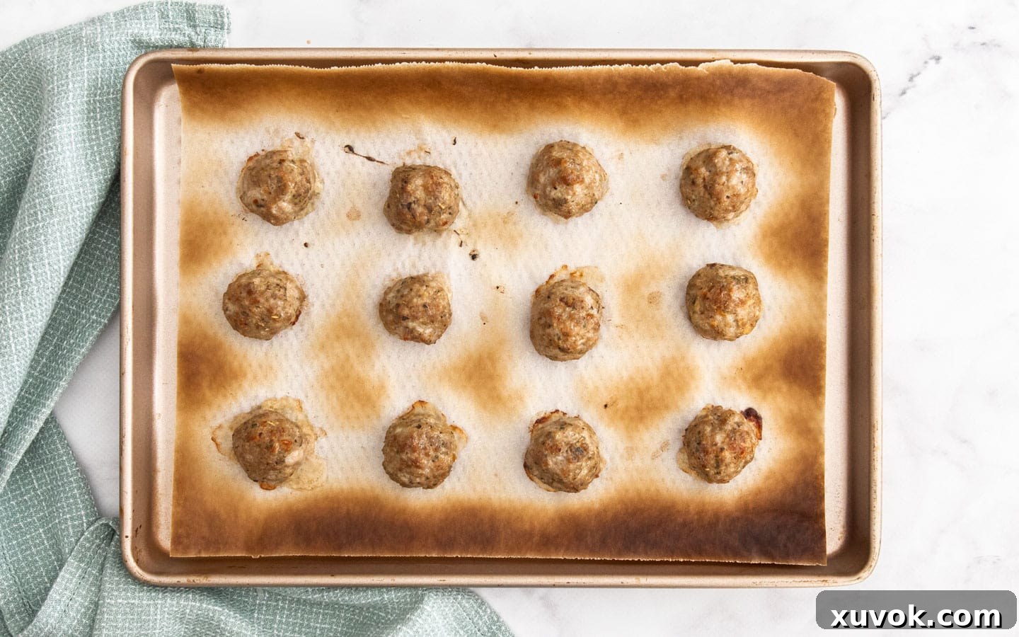 The cooked meatballs on a baking tray.