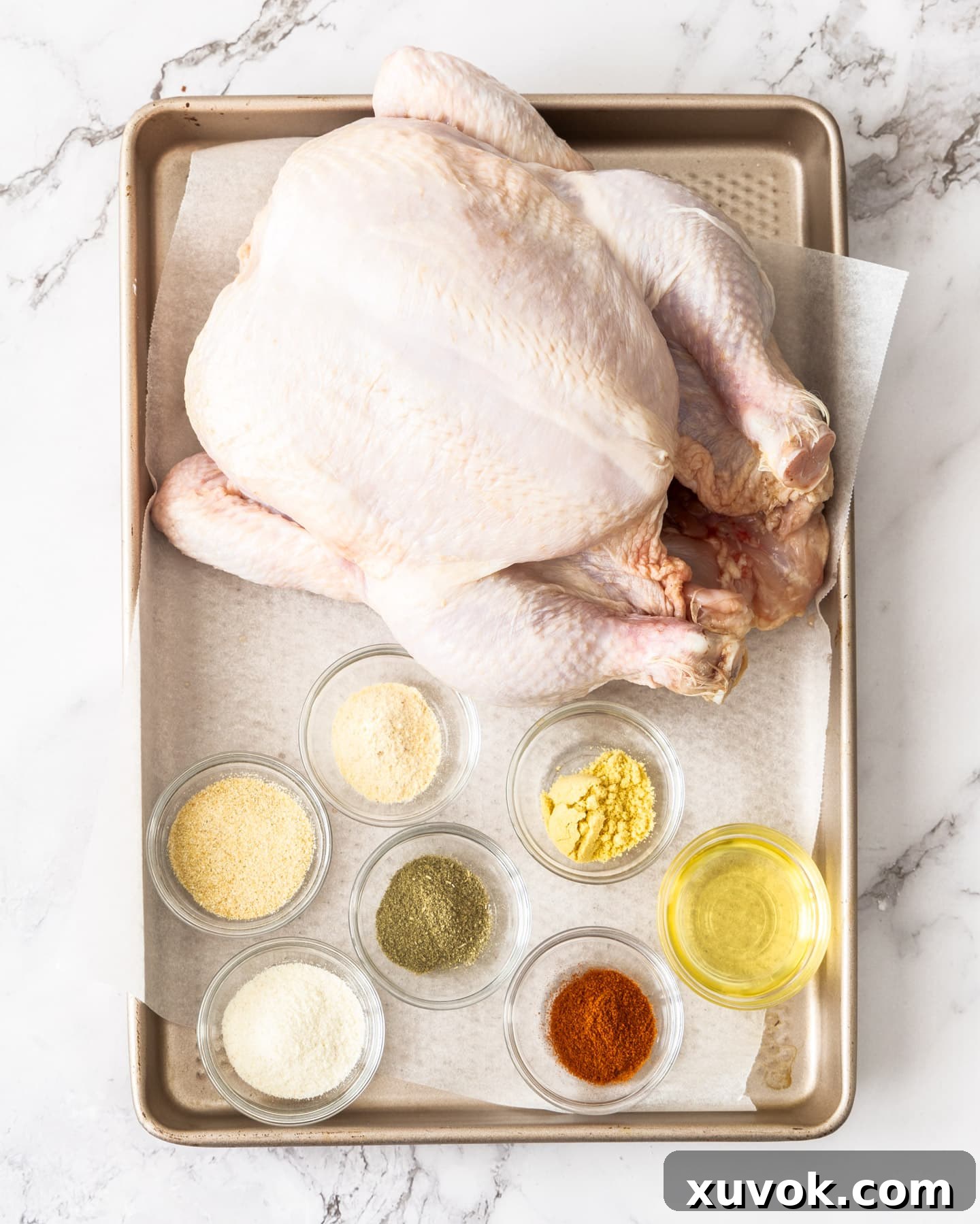 Ingredients for air fryer roast chicken on a baking tray.
