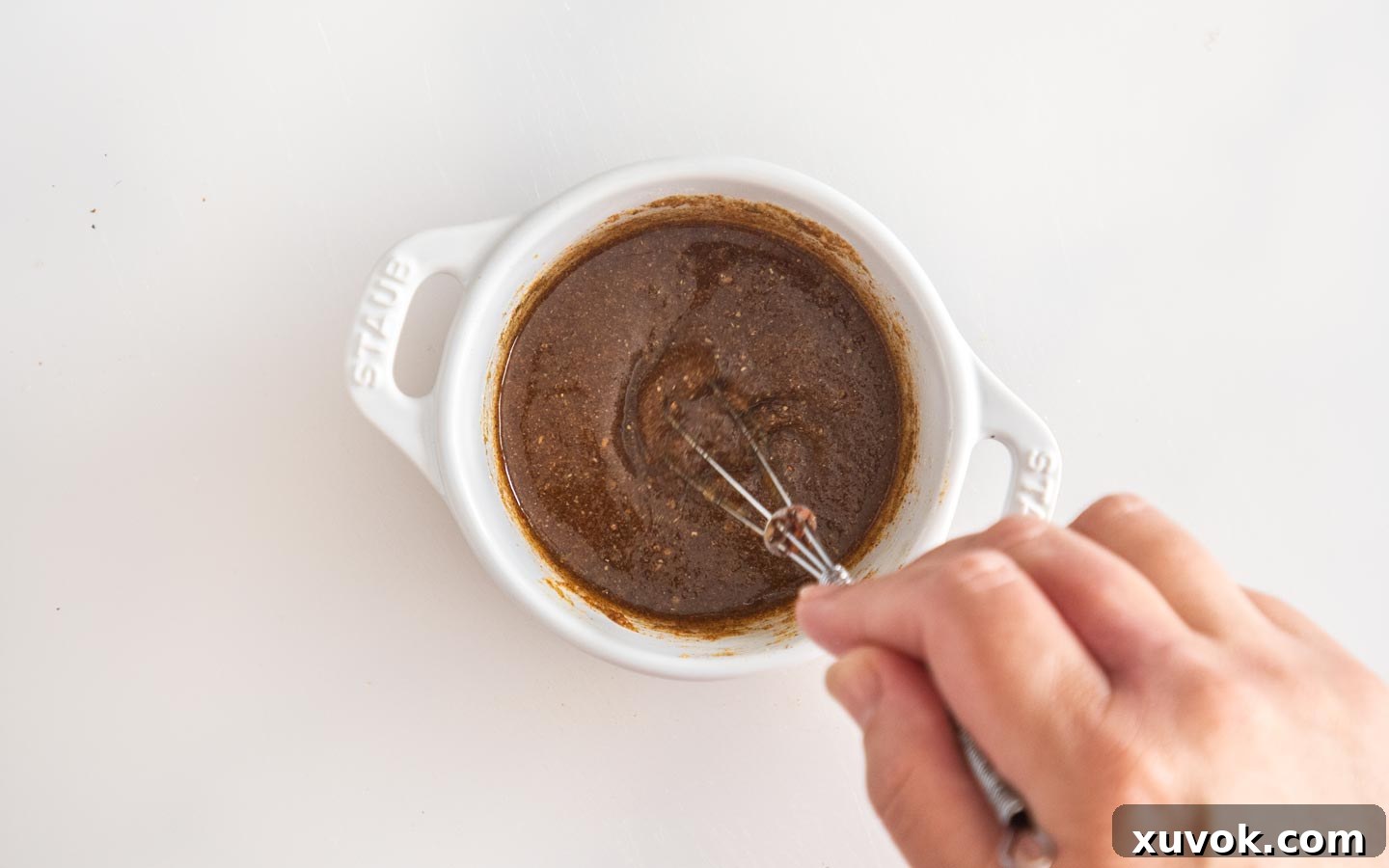 Whisking the seasoning together.