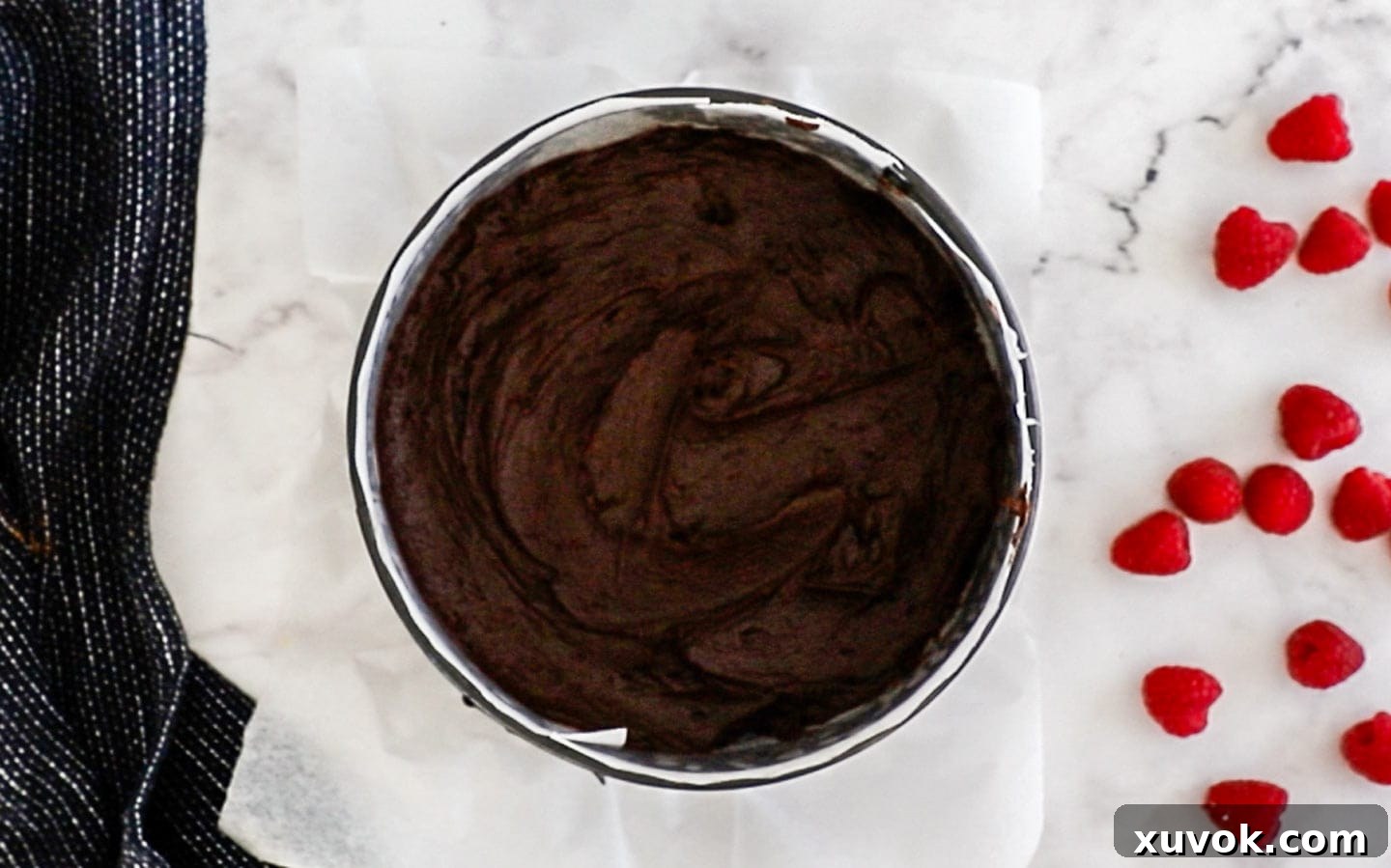 Brownie batter neatly spread in a baking pan, ready for the oven.