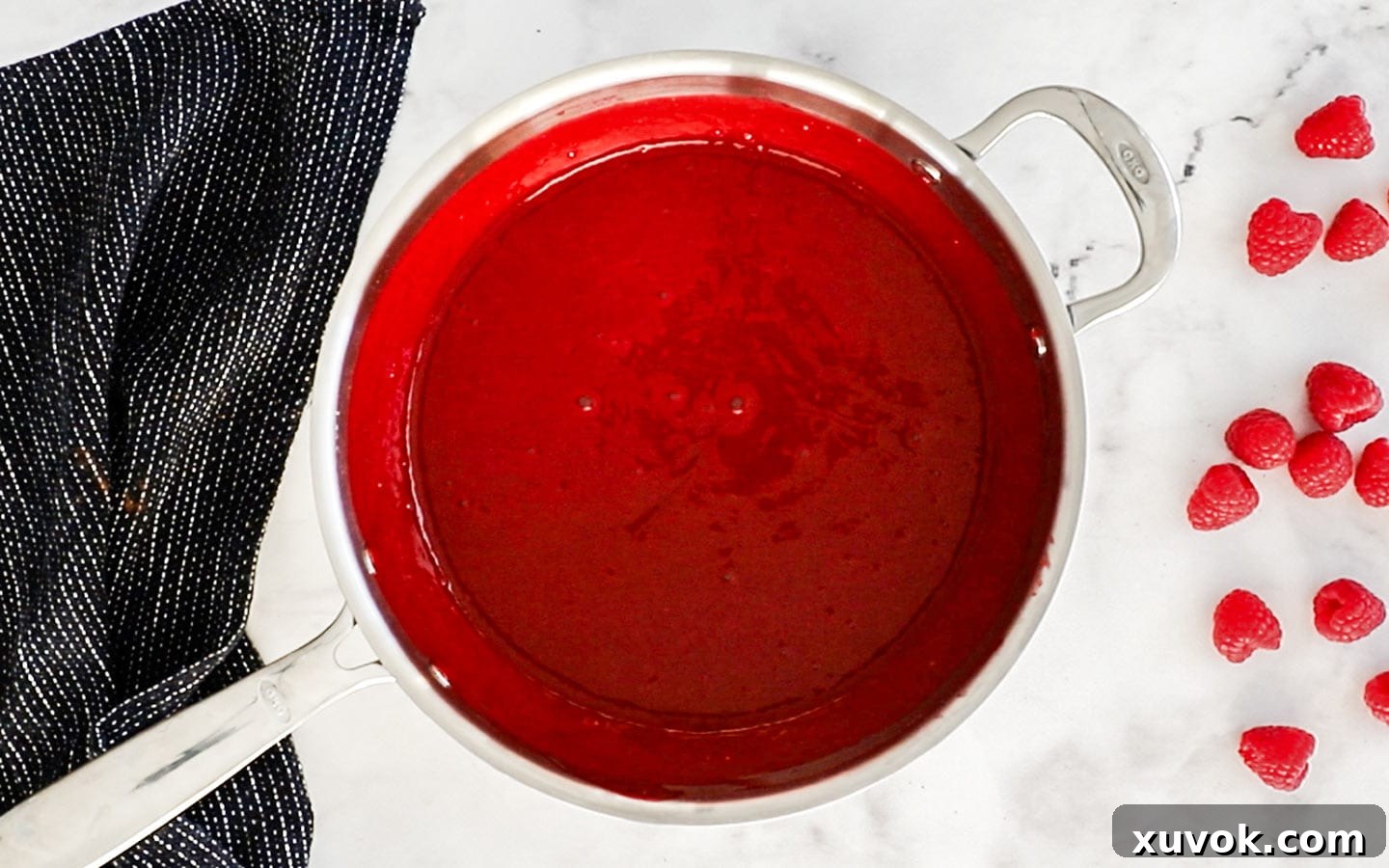Raspberry sauce in a saucepan, after gelatin has been added and stirred.