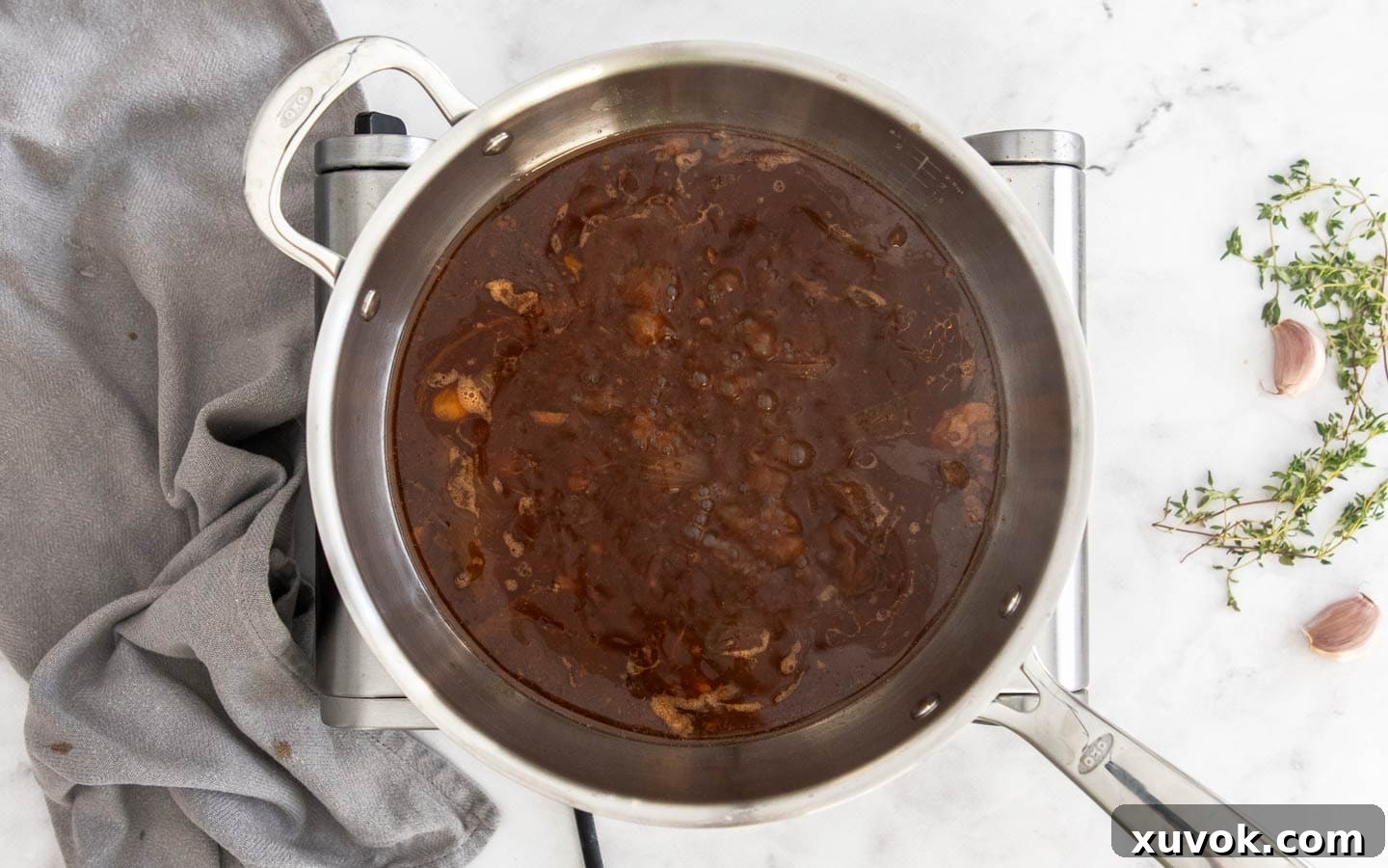 The savory gravy bubbling gently in a saucepan.