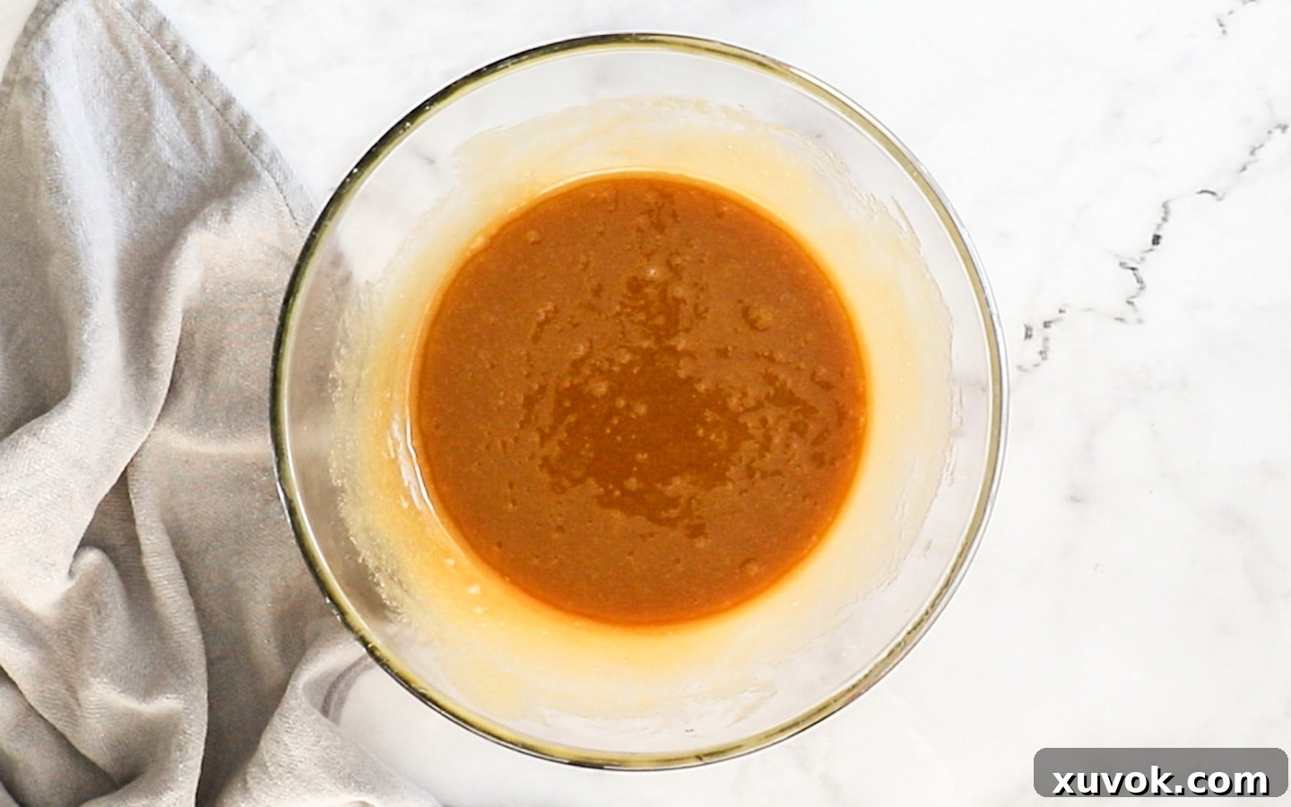 The wet ingredient mixture after eggs and vanilla have been incorporated, showing a smooth, well-emulsified batter.