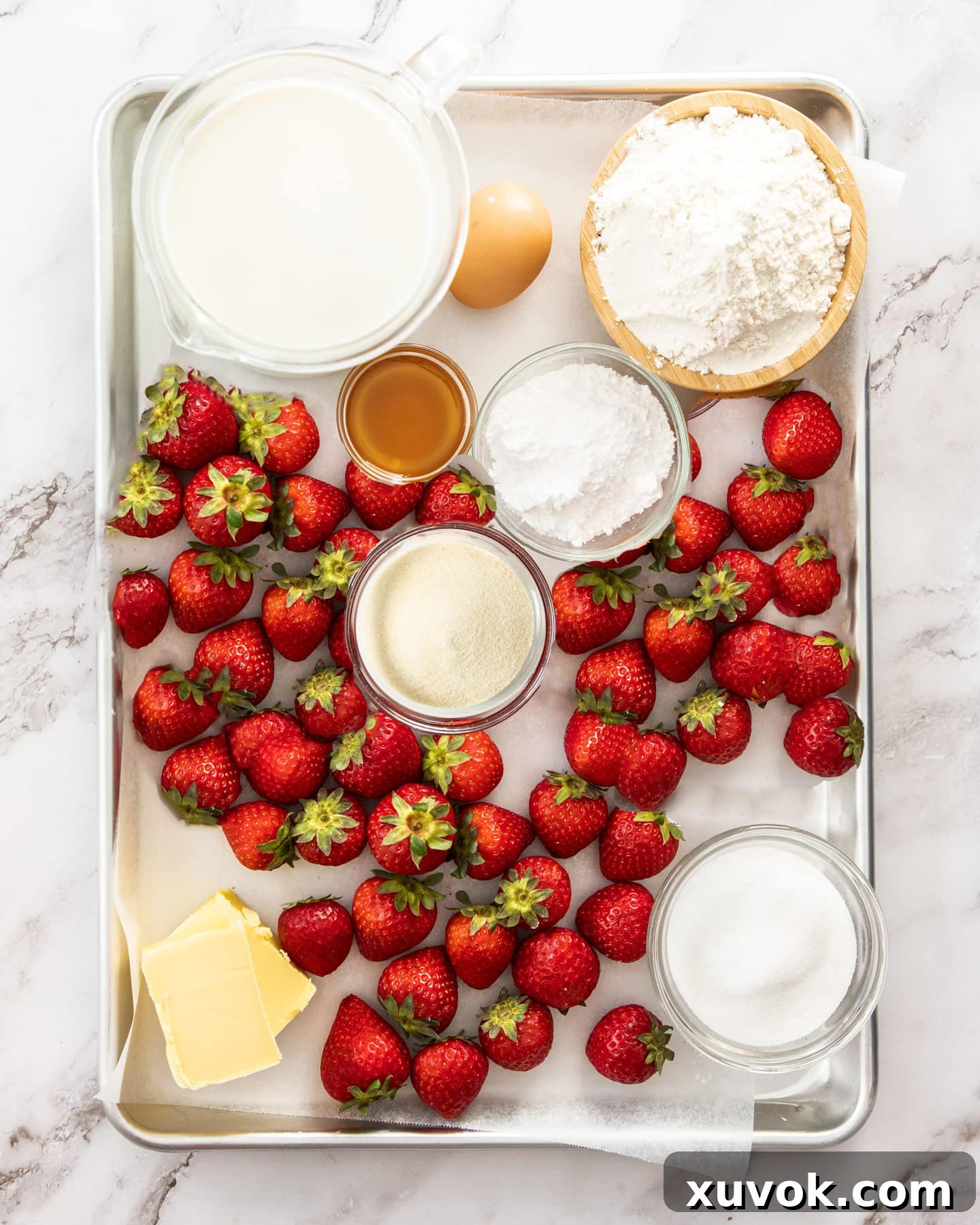 Ingredients for the strawberry mousse tart laid out on a baking tray.