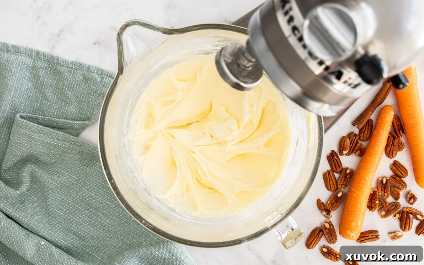 The cream cheese frosting after the whipping cream has been added and beaten, showing a light and fluffy consistency.